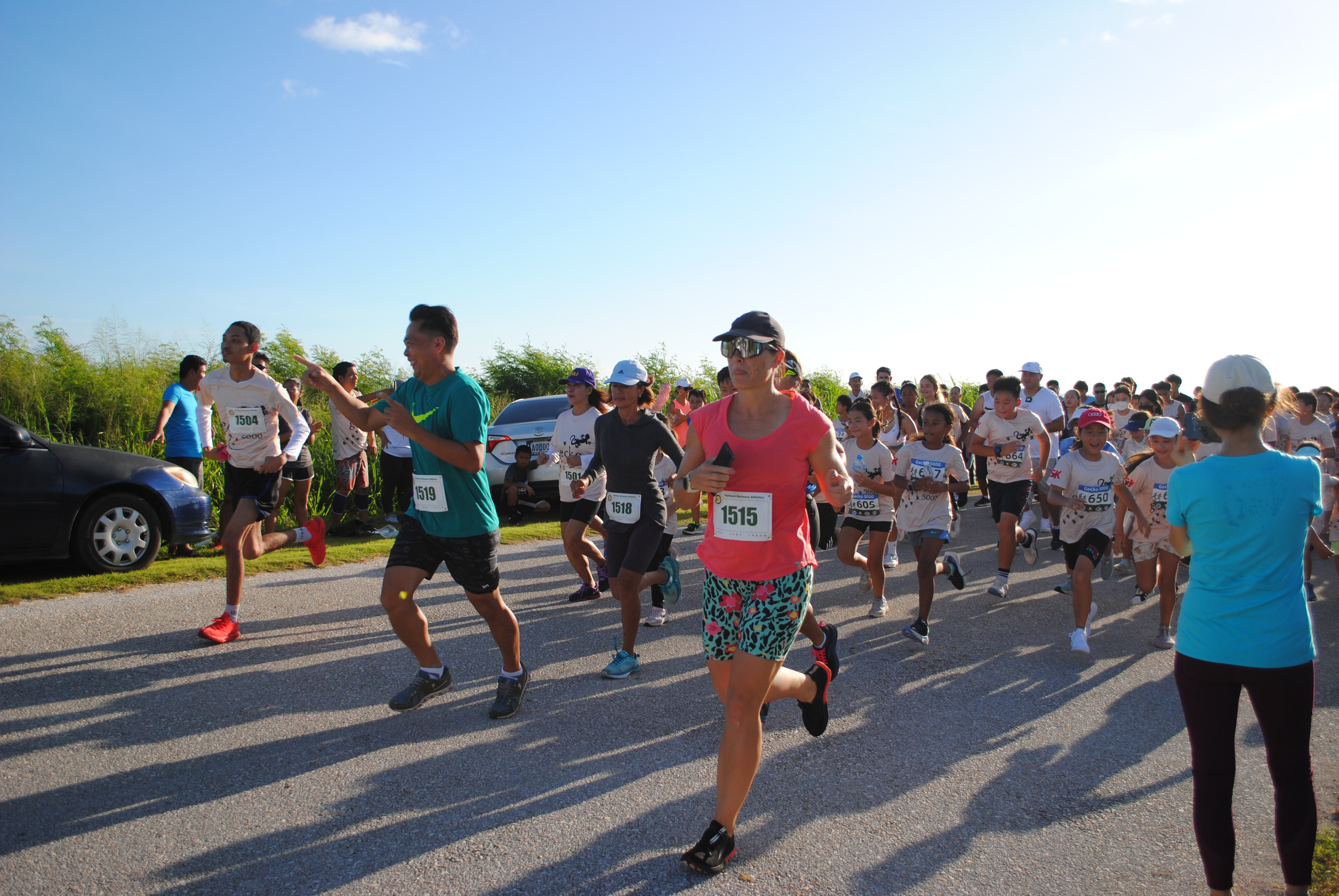 The participants of Gecko 5000’s 5K fun run and open divisions take off from the starting line at Banzai Cliff on Saturday.