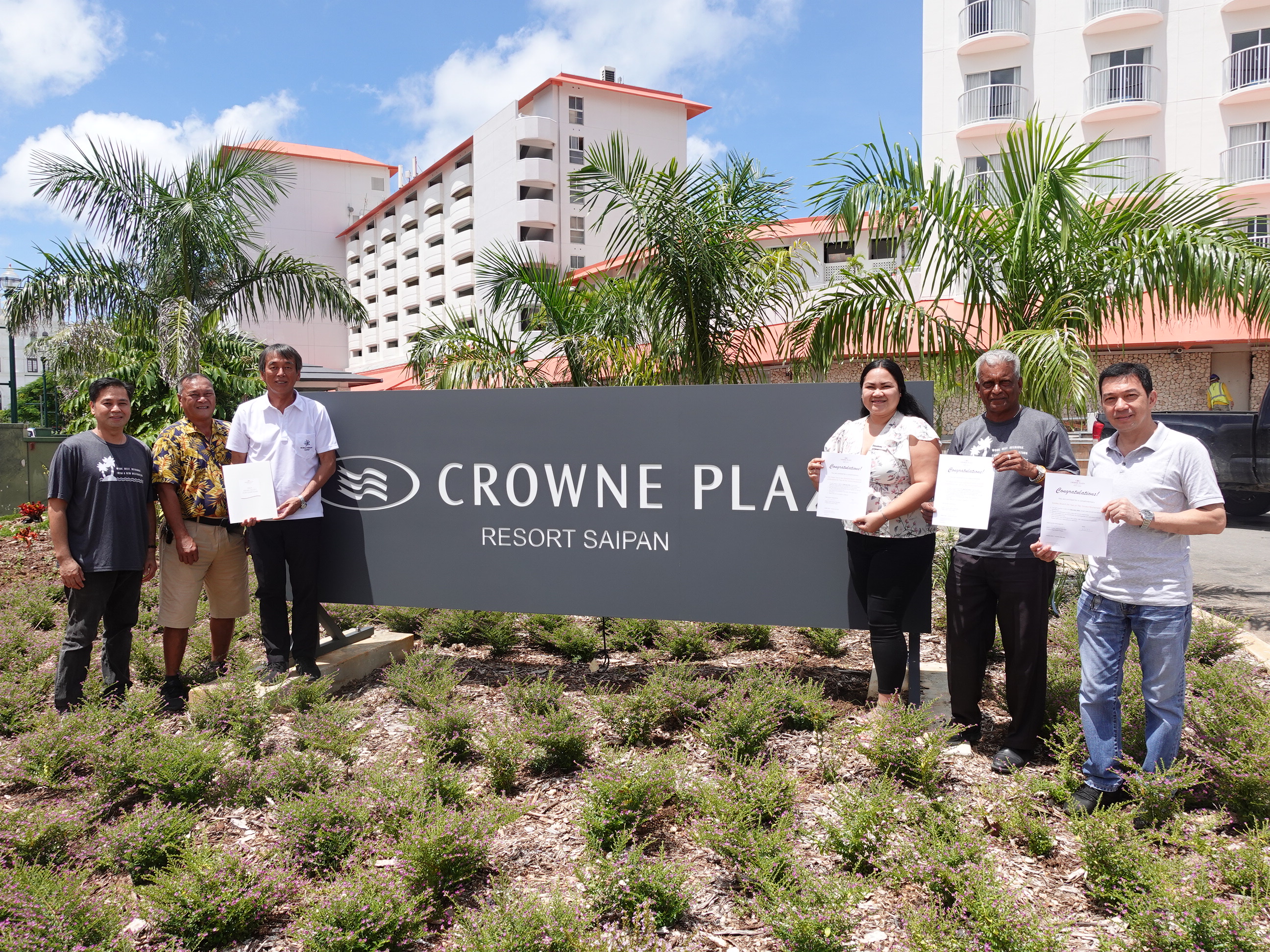 Crowne Plaza Resort Saipan F&B Director Das Krishnan, second right, and resort managers present accommodation and restaurant gift certificates on Sept. 7, 2022, in Garapan, Saipan, for the 20th Annual HANMI Charity Classic Golf Tournament on Sept. 17, 2022.   From left, outlets manager Ronald Sanchez, tournament committee member Max Concepcion, tournament committee chairman Juko Ishikawa, rooms reservations manager Sunshine Saures, Krishnan, and beverage manager Jeffrey Cruz.