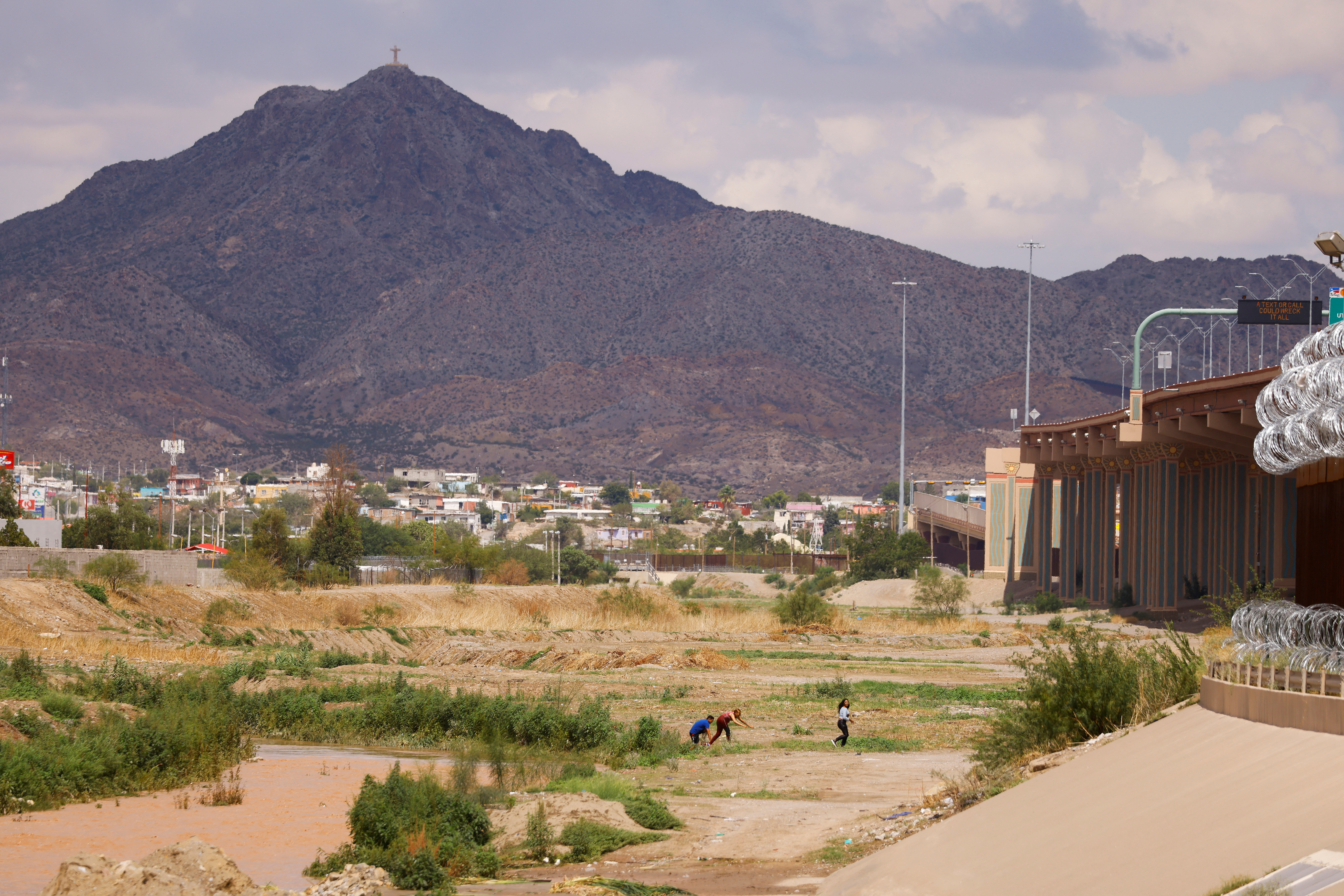 Asylum-seeking migrants are seen after crossing the Rio Bravo river to request asylum in El Paso, Texas, as seen from Ciudad Juarez, Mexico, Aug. 23, 2022.