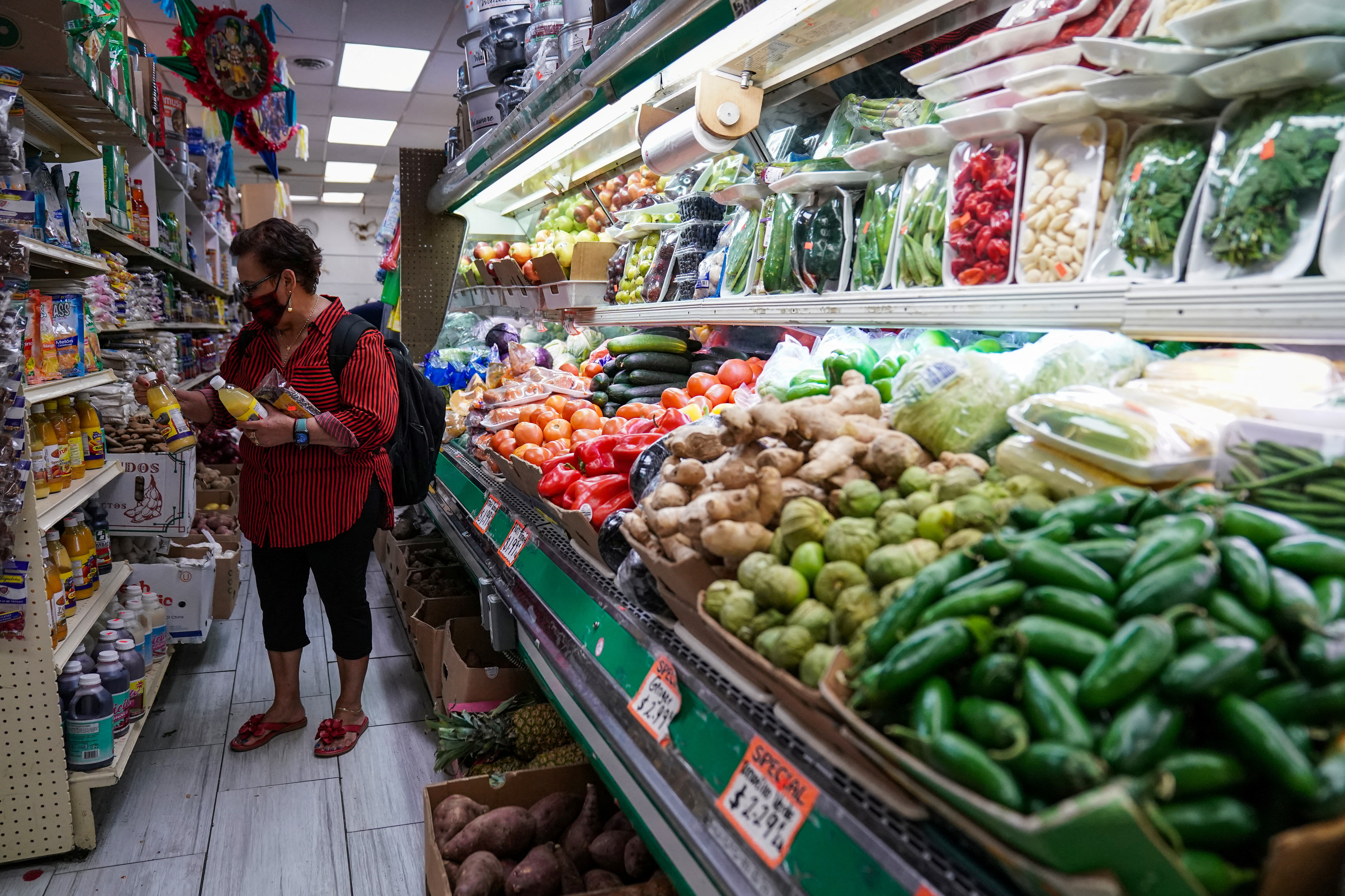A woman shops for groceries at El Progreso Market in the Mount Pleasant neighborhood of Washington, D.C.,  Aug. 19, 2022.