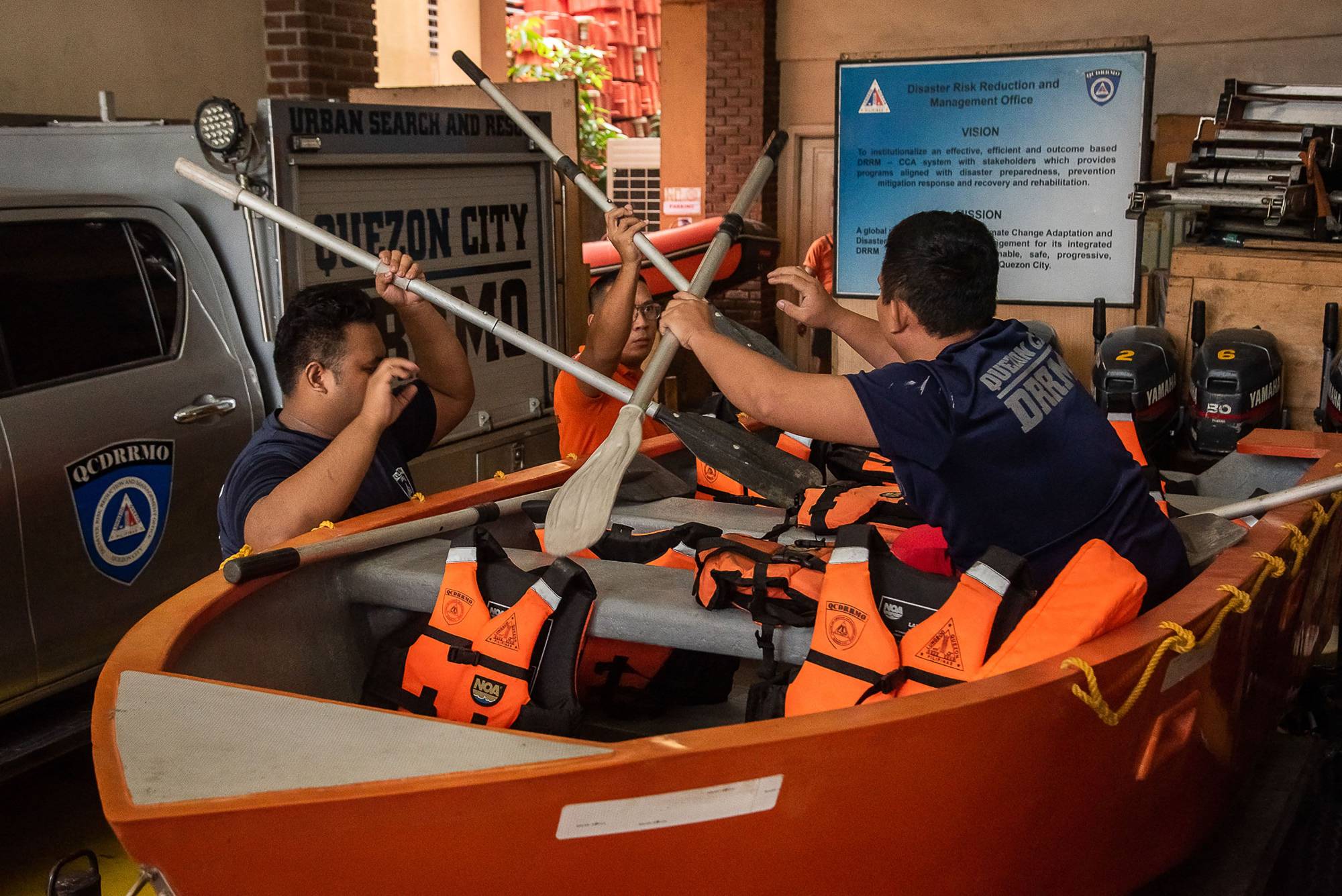 Members of the Disaster Risk Reduction and Management Office prepare rubber boats and life vests ahead of Super Typhoon Noru's landfall, at their headquarters in Quezon City, Metro Manila, on Sunday.
