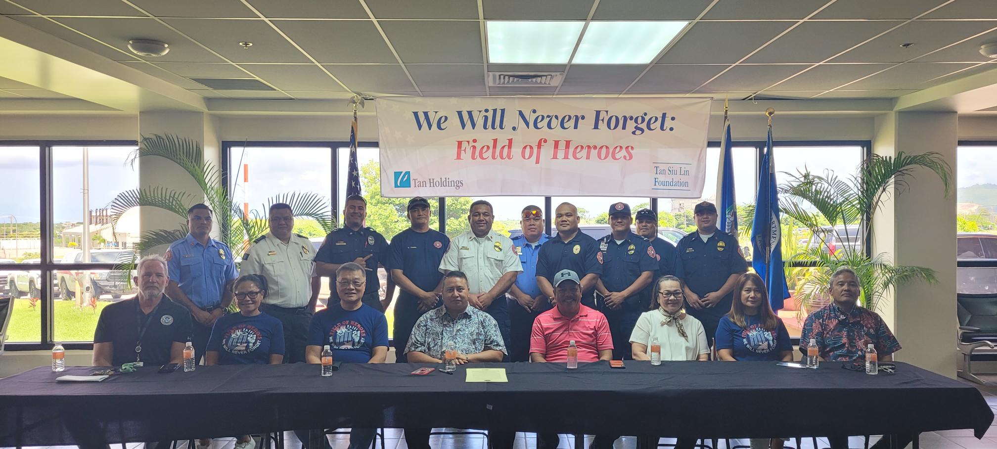 Department of Fire and Emergency Medical Services first responders pose for a photo with officials.