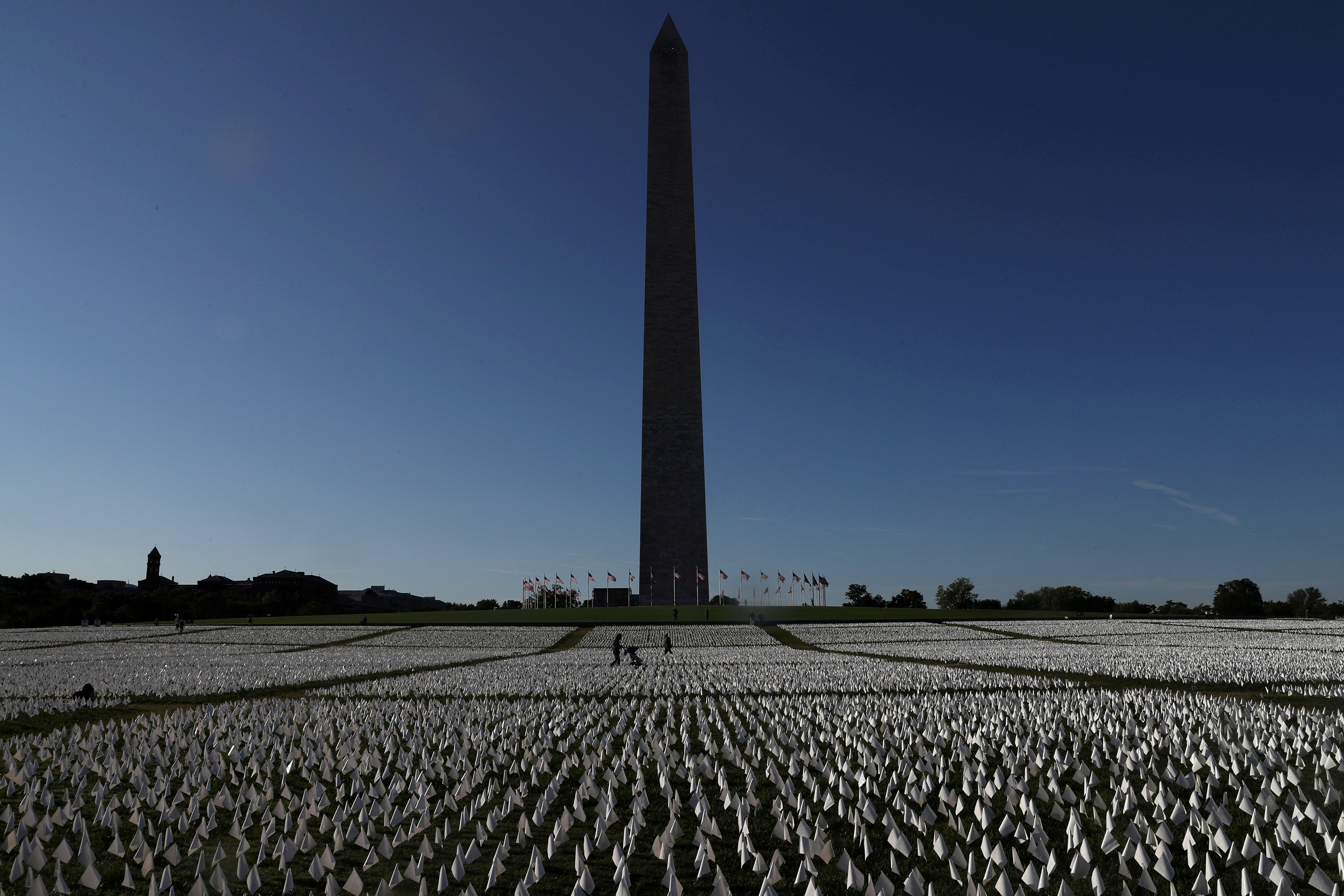 People visit Suzanne Brennan Firstenberg's "In America: Remember," a memorial for Americans who died due to the coronavirus disease next to the Washington Monument in Washington, D.C., Oct. 1, 2021.