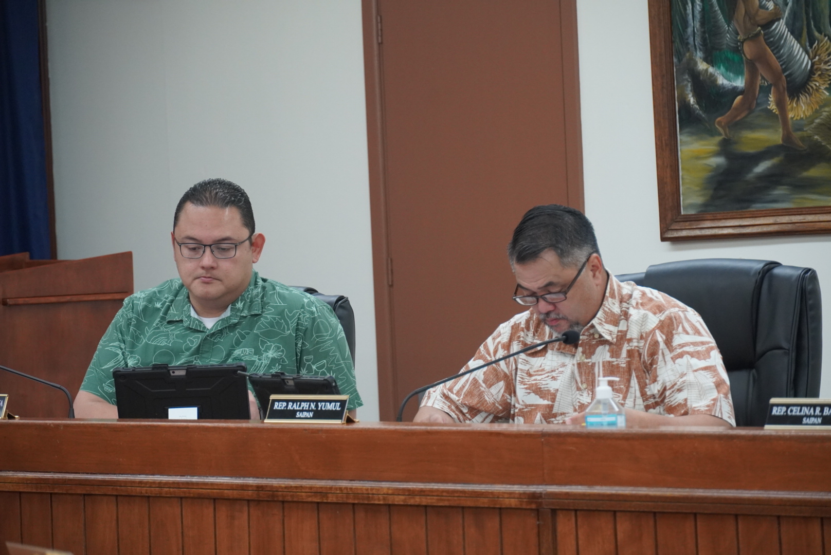 House Conference Committee chair Rep. Donald M. Manglona, left, and House Floor Leader Ralph N. Yumul, right, review documents prior to the conference committee meeting on Thursday afternoon in the Senate chamber.