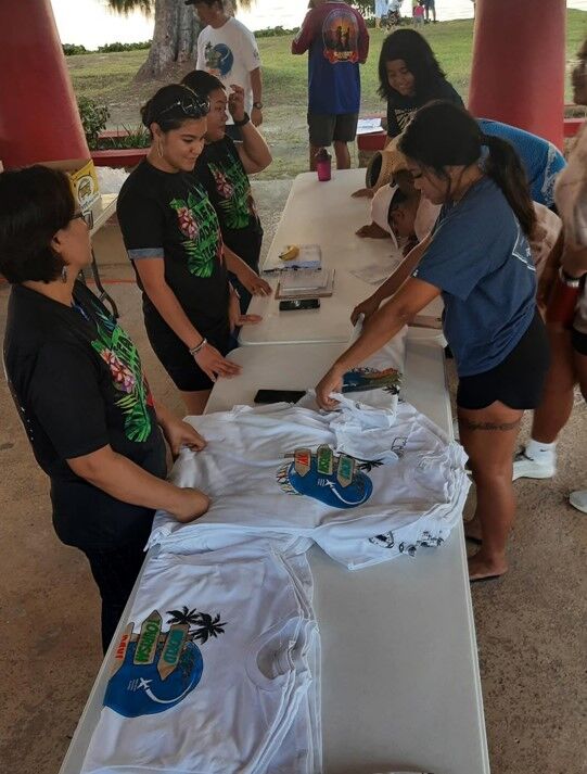 Participants register and receive free t-shirts at the World Tourism Day Sunset Walkathon on Sept. 27, 2022,  beginning at Mina'chom Atdao in Saipan in celebration of World Tourism  Day.  Walks were also held in Tinian and Rota.
