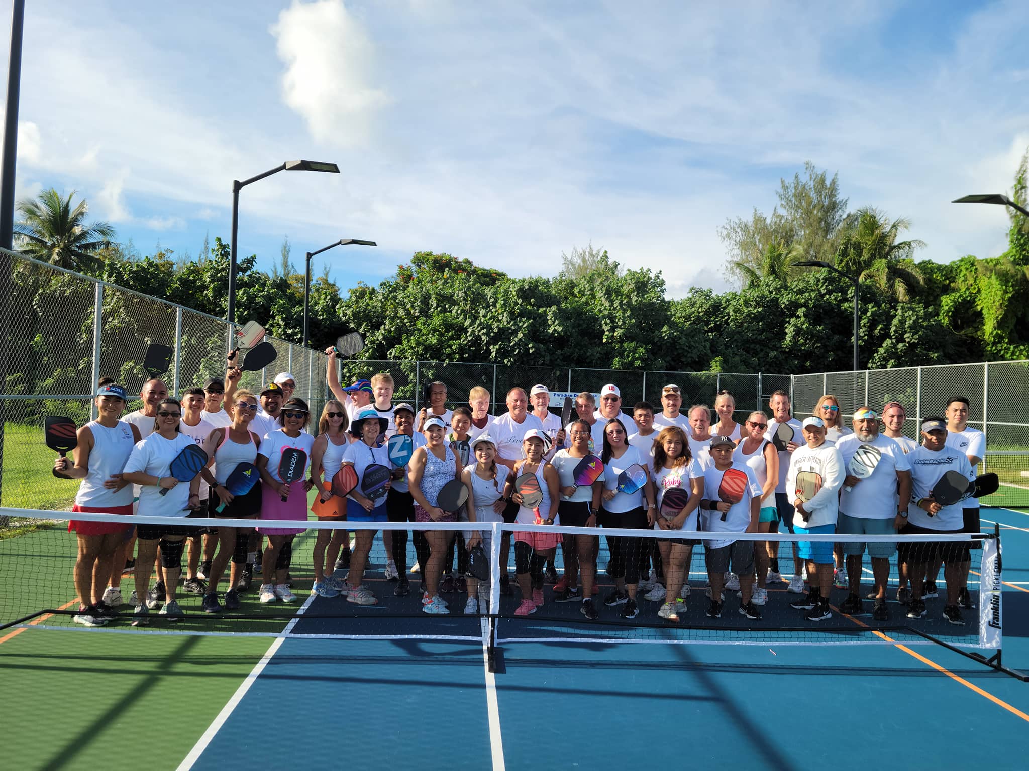 Players participating in the Pickleball "King's Court" Tournament pose for a photo on Saturday at American Memorial Park.