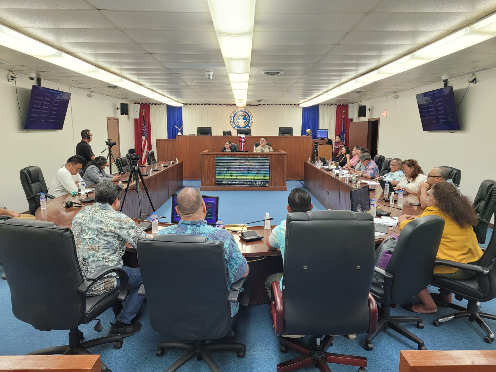 House Ways and Means Chair Donald Manglona, right background, and Vice Chair Corina Magofna, left background, preside over a press conference Friday in the House chamber.