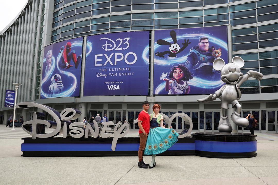 People pose for a photo at Disney's D23 Expo in Anaheim, California, Sept. 9, 2022.
