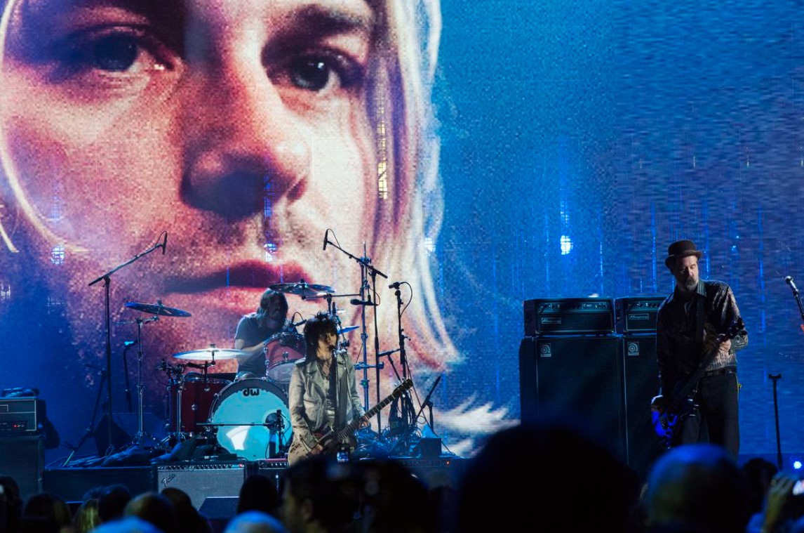 Joan Jett, center, performs with Dave Grohl and Krist Novoselic, right, of Nirvana after the band was inducted during the 29th annual Rock and Roll Hall of Fame Induction Ceremony at the Barclays Center in Brooklyn, New York, April 11, 2014.