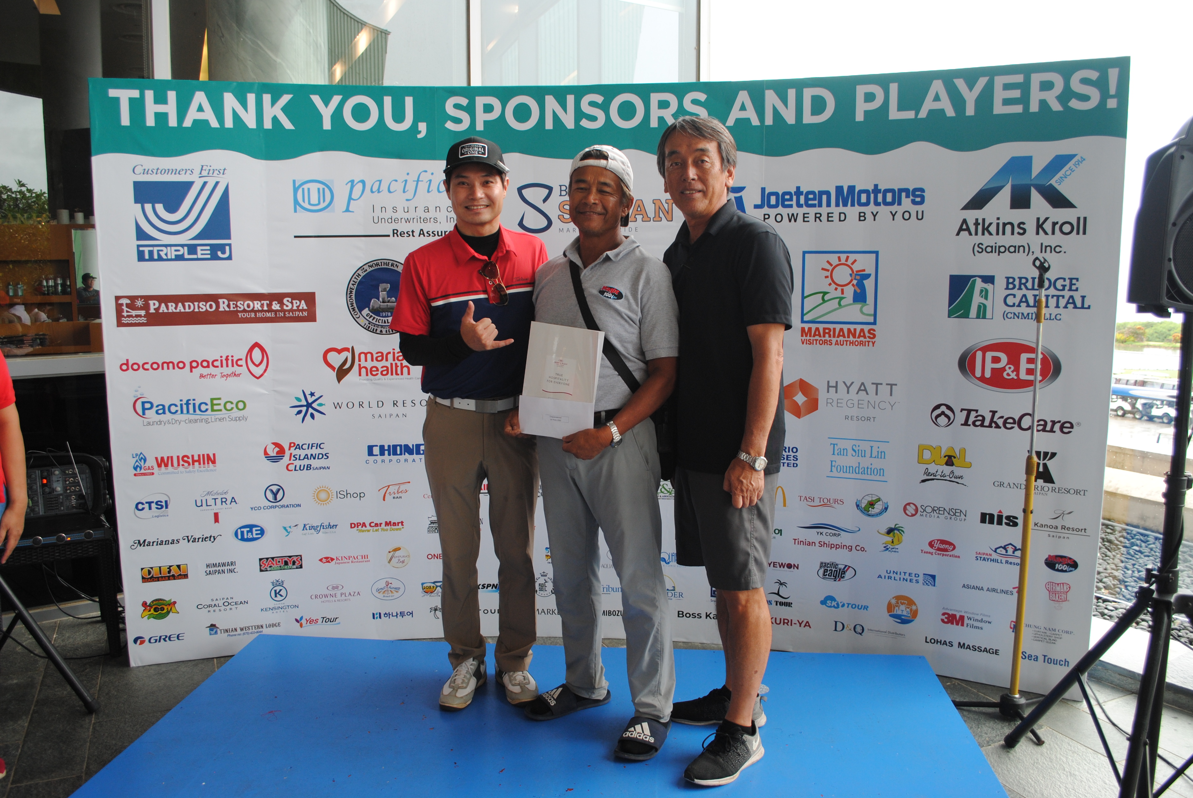 Leo Ganacias, center, is the winner of the 2022 HANMI Charity Classic Golf Tournament on Saturday at Laolao Bay Golf & Resort.