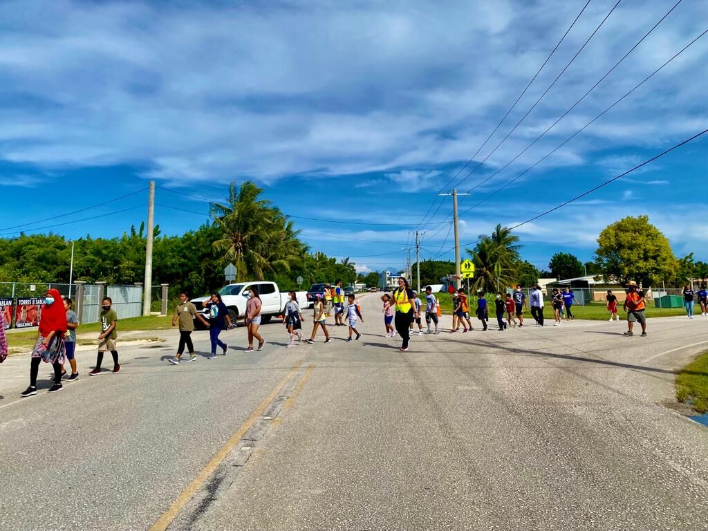 WSR Elementary School students cross and intersection on their way to As Perdido.