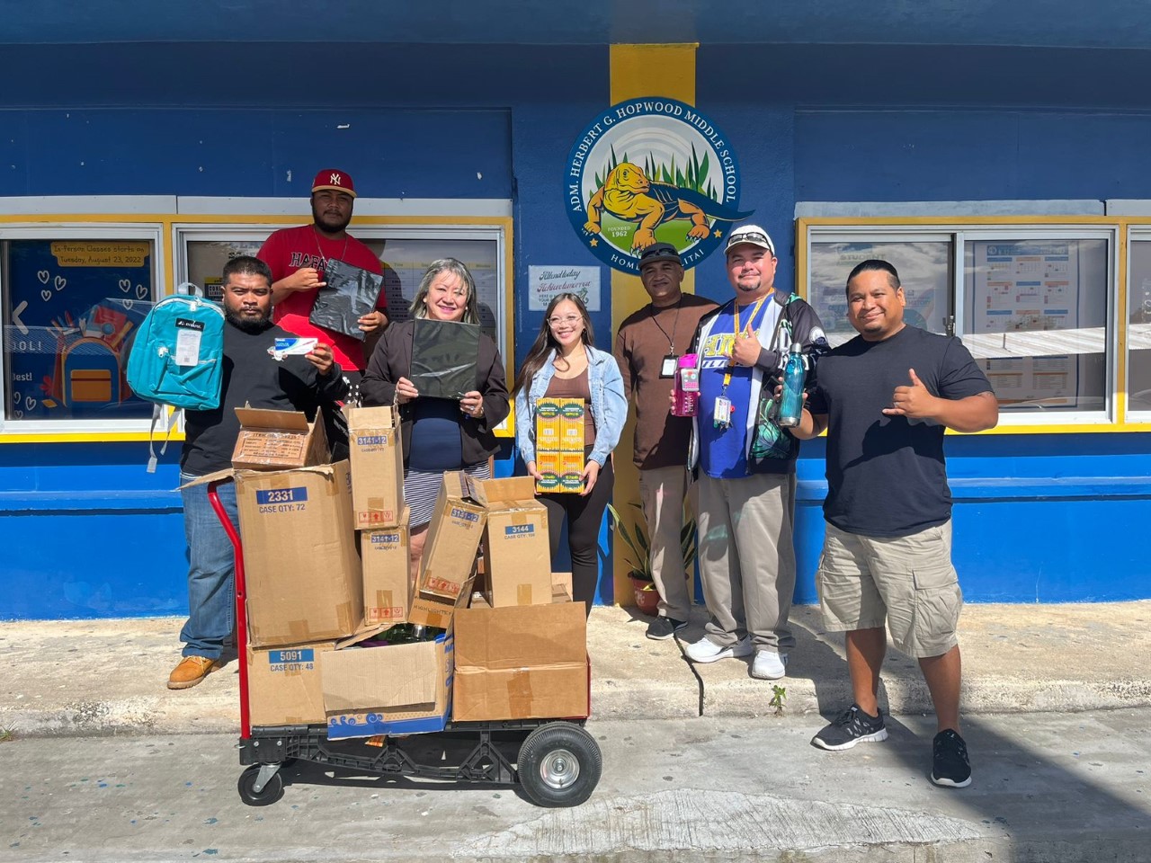Sen. Edith Deleon Guerrero, third left, poses for a photo with Hopwood Middle School Principal Victorino Borja, second right, and teacher with the school supplies donated by the senator on Friday.