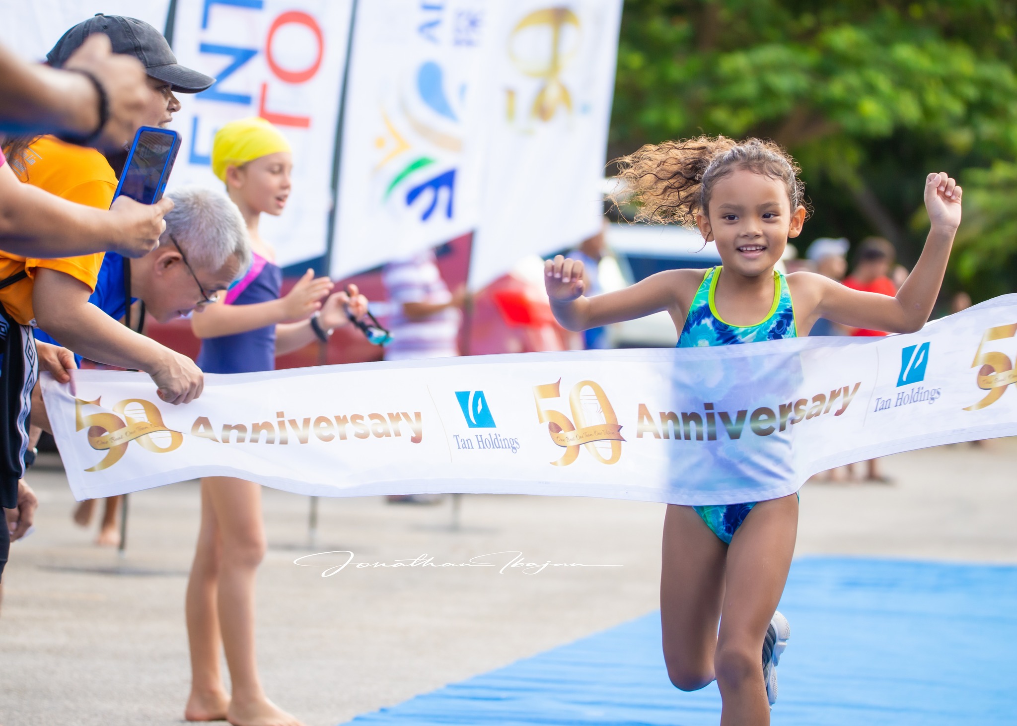 Quinn Bauer crosses the finish line of the Tan Holdings Taga Kids Triathlon at  Paupau Beach in San Roque.