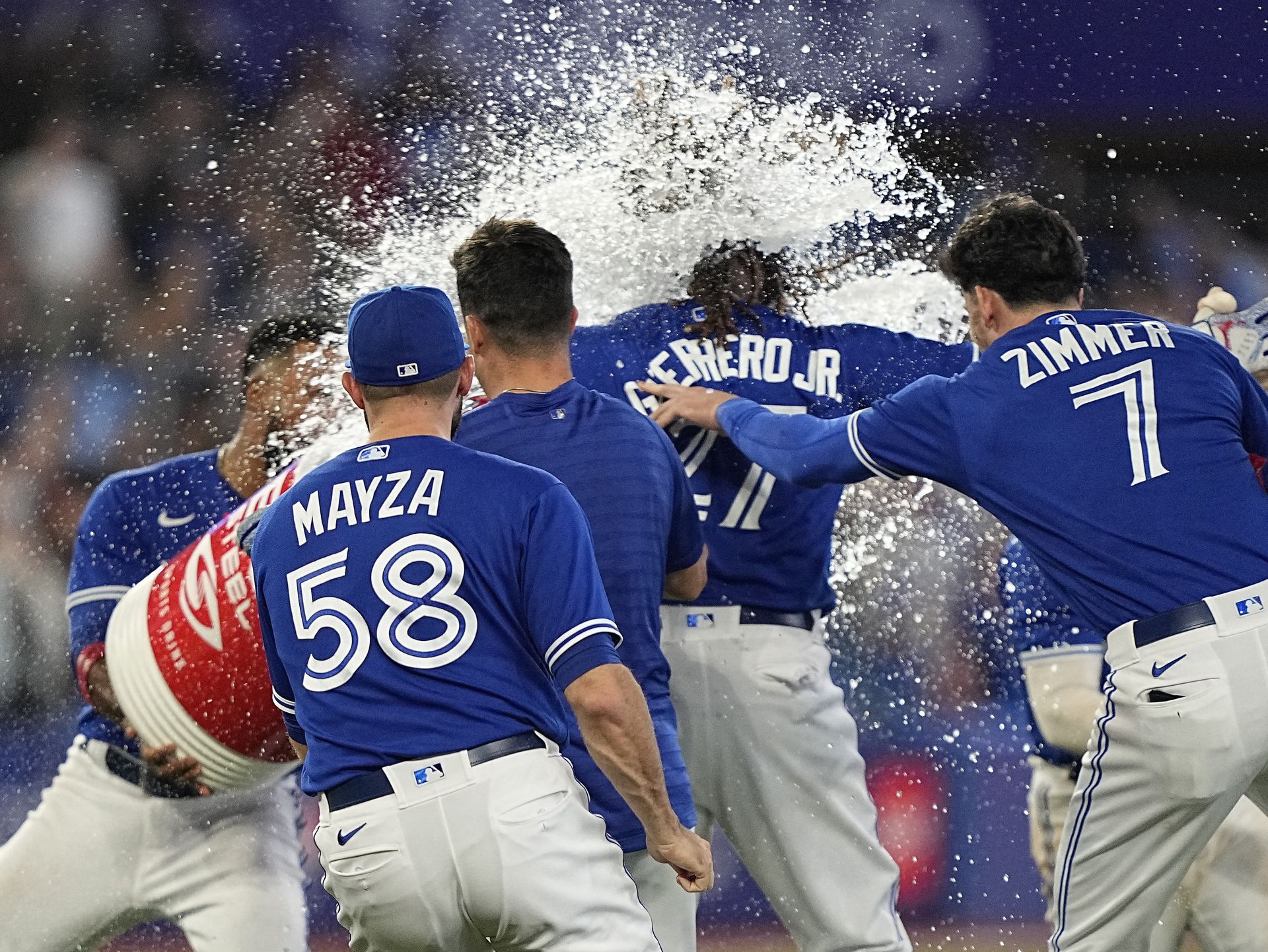 Toronto Blue Jays first baseman Vladimir Guerrero Jr. (27) gets doused with water after hitting a walk-off single against the New York Yankees during the tenth inning at Rogers Centre in Toronto, Ontario, Canada on Sept. 26, 2022.