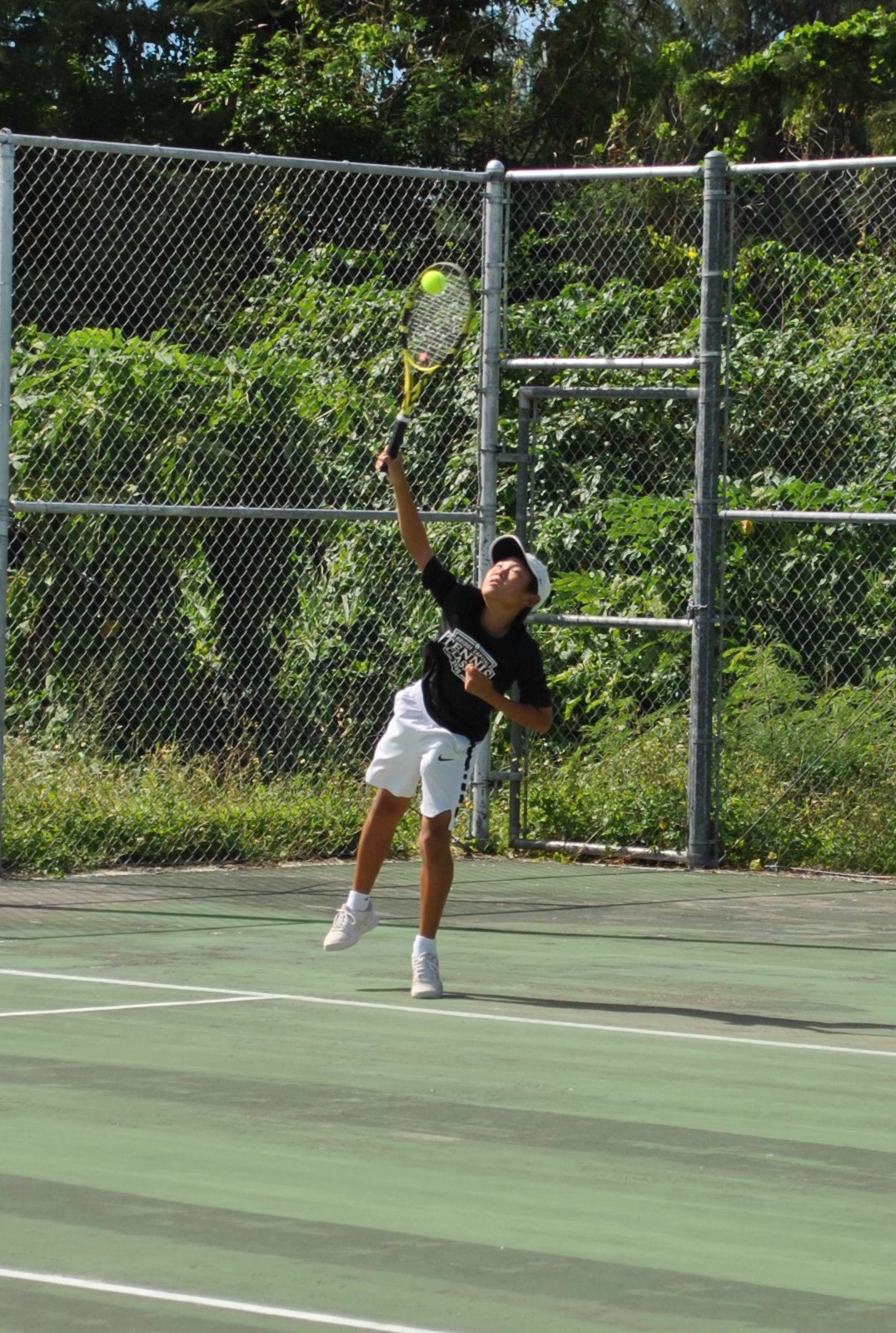 June Yu attempts the forehand return during a tennis match at American Memorial Park.