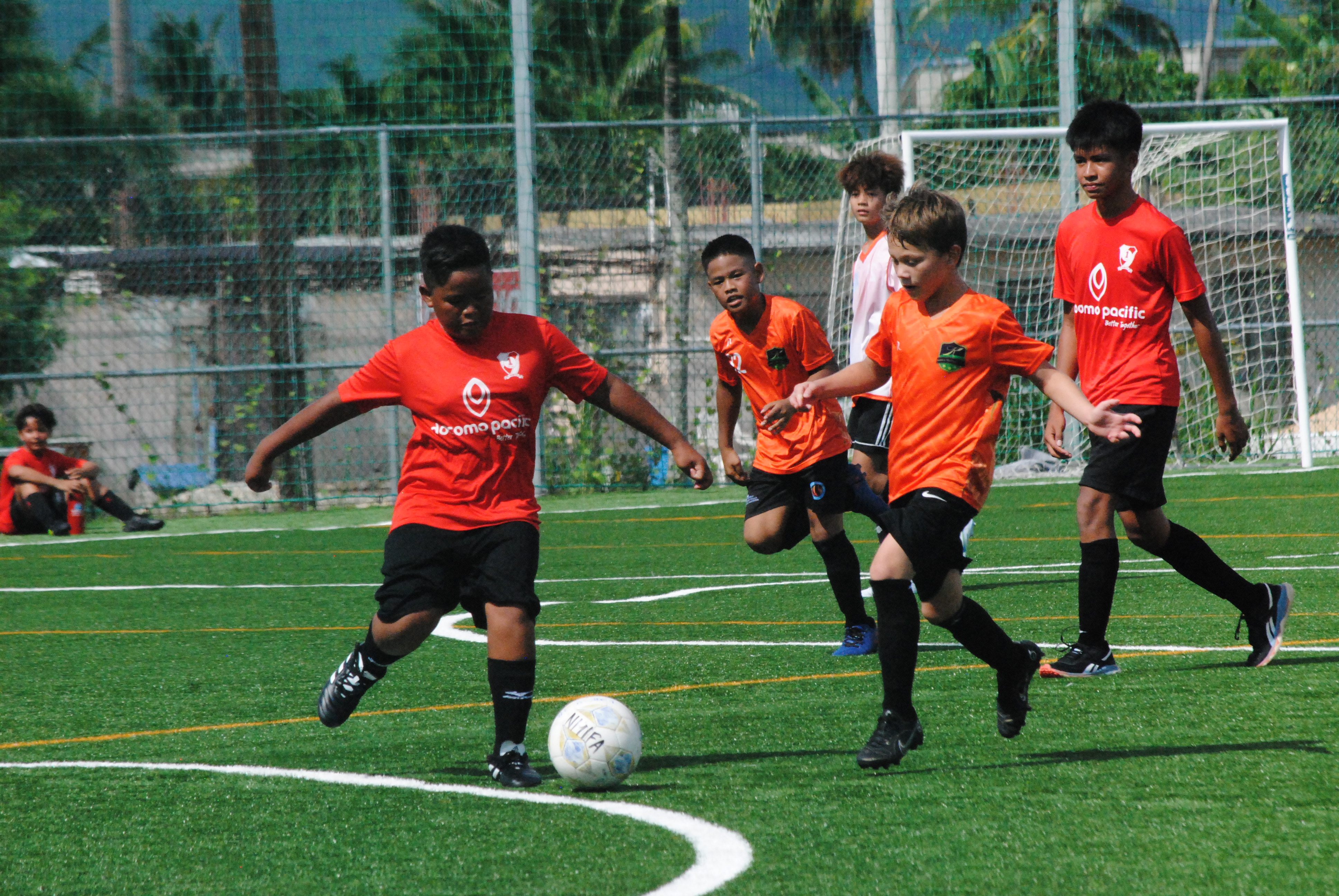 Kanoa's Jude Rayphand closes in on a Paire player as they battle for the possession during a U13 Boys Division game of the Fall 2022 TakeCare Youth Soccer League at the NMI Soccer Training Center.