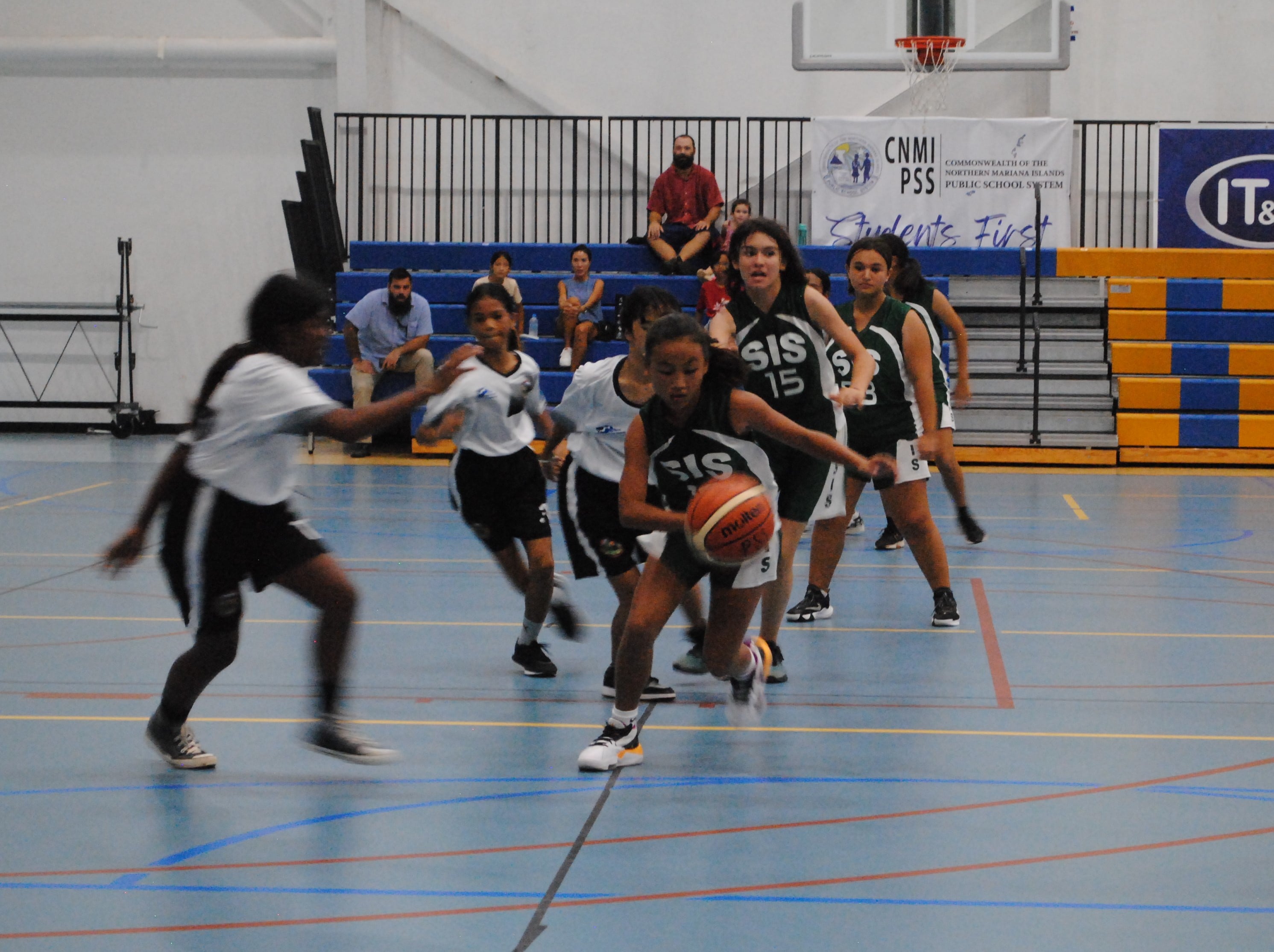 SIS' Aubrey White dribbles past defenders during a Girls Middle School Division game of the IT&E Interscholastic Basketball League Friday at MHS gym.