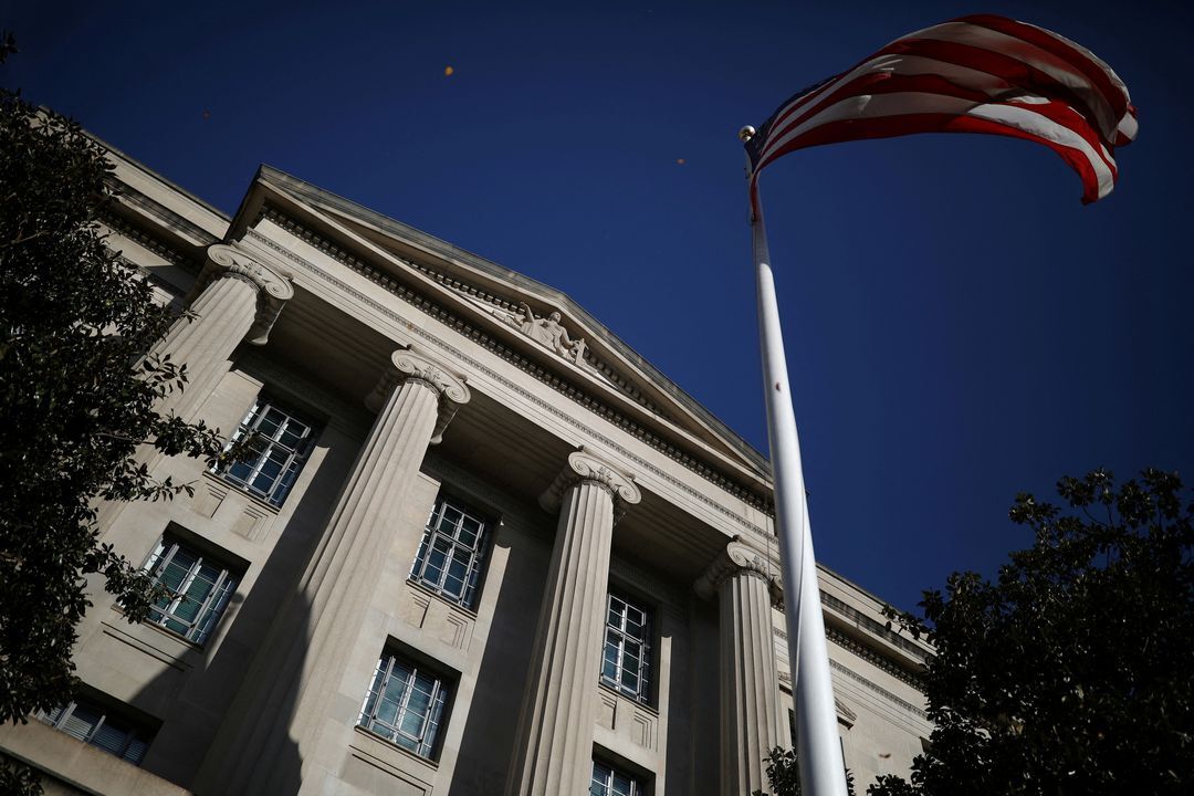 An American flag waves outside the U.S. Department of Justice Building in Washington, D.C., Dec. 2, 2020.