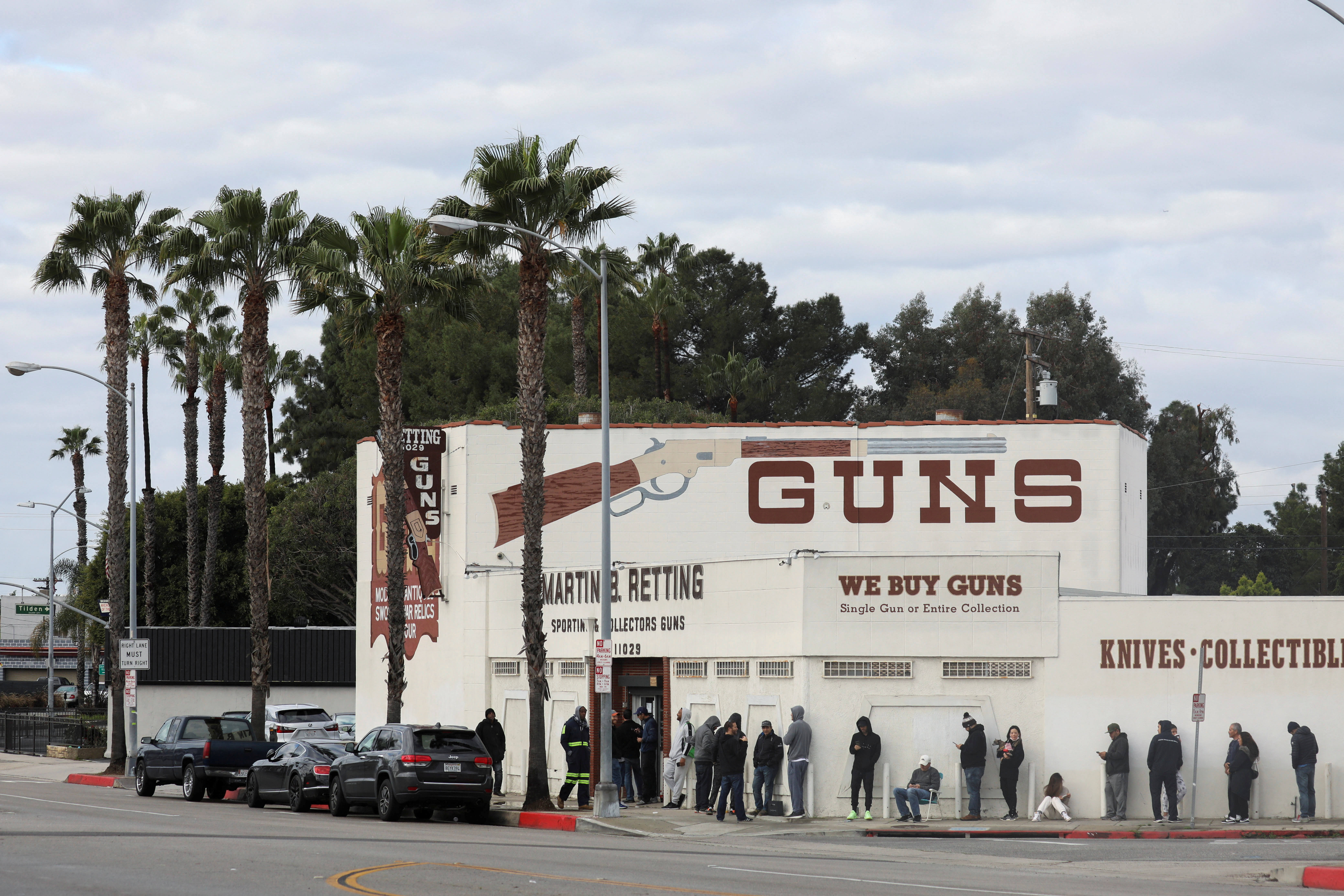 People wait in line outside to buy supplies at the Martin B. Retting Inc. gun store amid fears of the global growth of coronavirus cases, in Culver City, California, March 15, 2020.