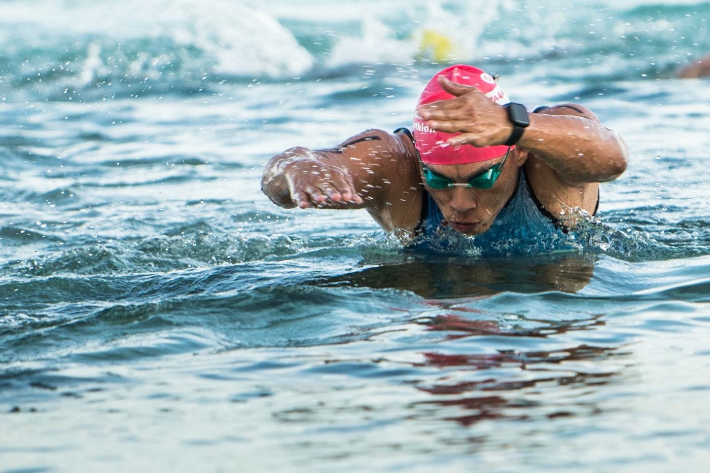 Nap Dizon pushes through the final leg of swimming during the 50th Tan Holdings Anniversary Triathlon at Paupau Beach in San Roque on Saturday.