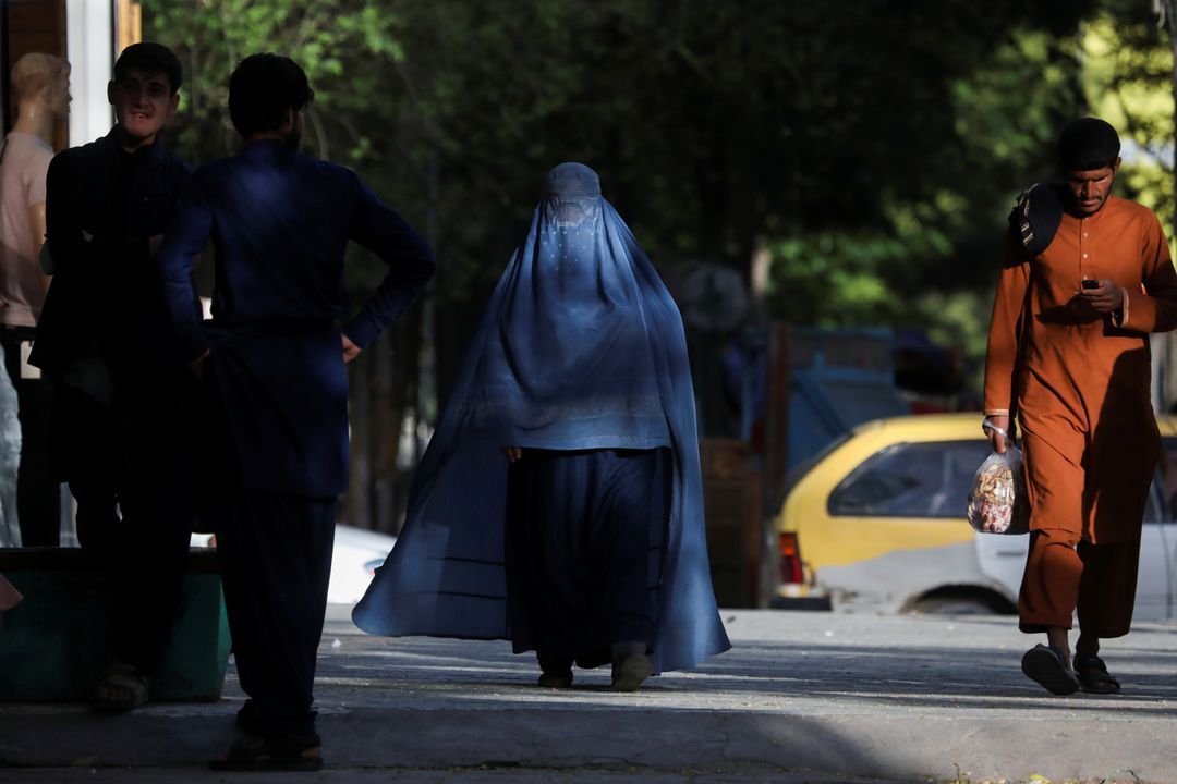 An Afghan woman walks on a street in Kabul, Afghanistan, May 9, 2022.