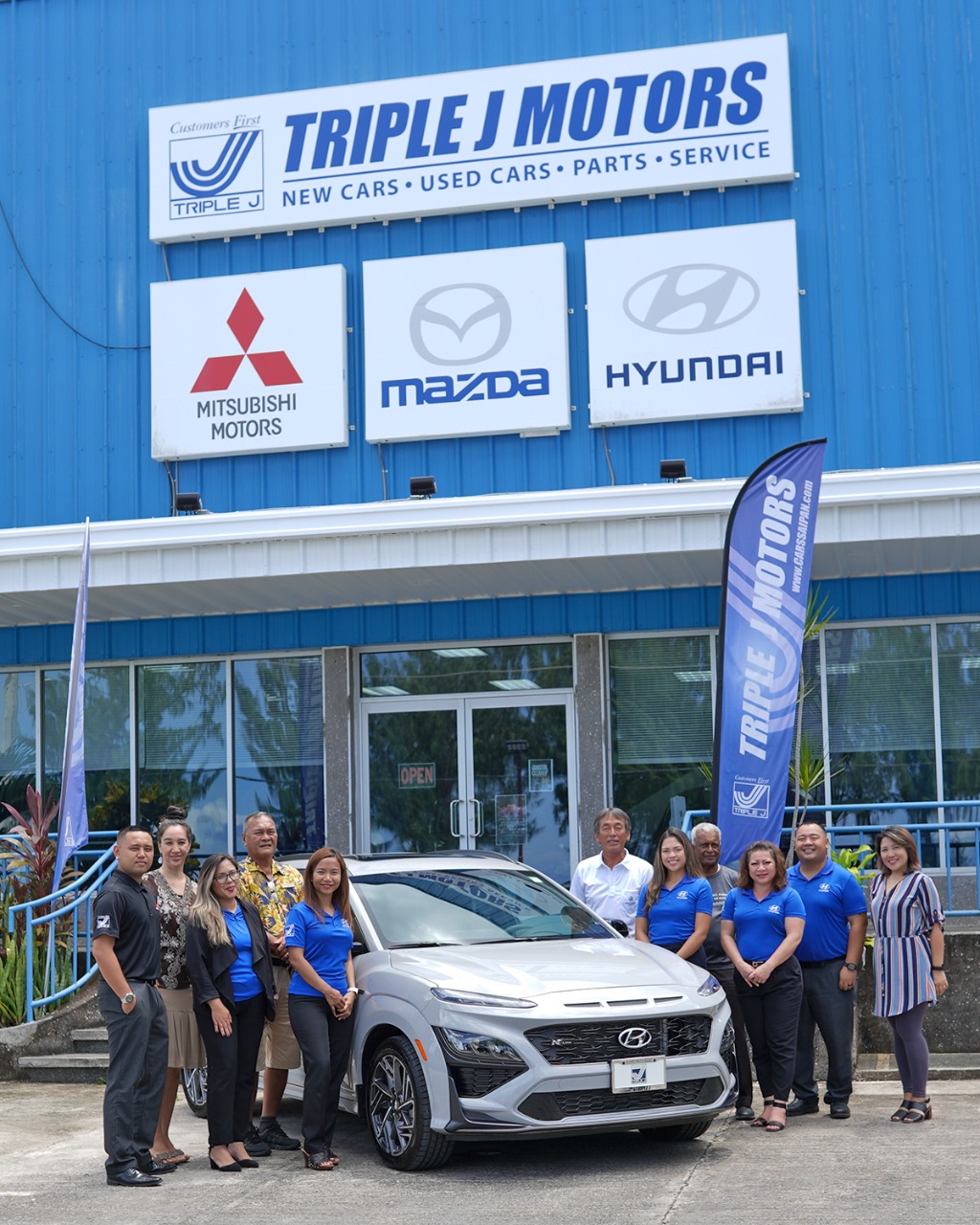 Triple J Motors New Car Sales Manager Jasmine  Matsumoto, fifth  left,  and company staff present a 2022 Hyundai Kona on September 7, 2022, in Chalan Laulau, Saipan, as a hole-in-one prize for the 20th Annual HANMI Charity Classic Golf Tournament to be held on Sept. 17, 2022 at LaoLao Bay Golf & Resort. From left, sales representative Brandon Santos, tournament committee member Catherine Perry, sales representative Jamie Barcinas, tournament committee member Max Concepcion, Matsumoto,  tournament  committee  chairman  Juko  Ishikawa,  sales  representative  Marie  Aldan, tournament committee member Das Krishnan, sales representatives Julie Ogo and Sherman Santos, and marketing assistant Donna Pastula.