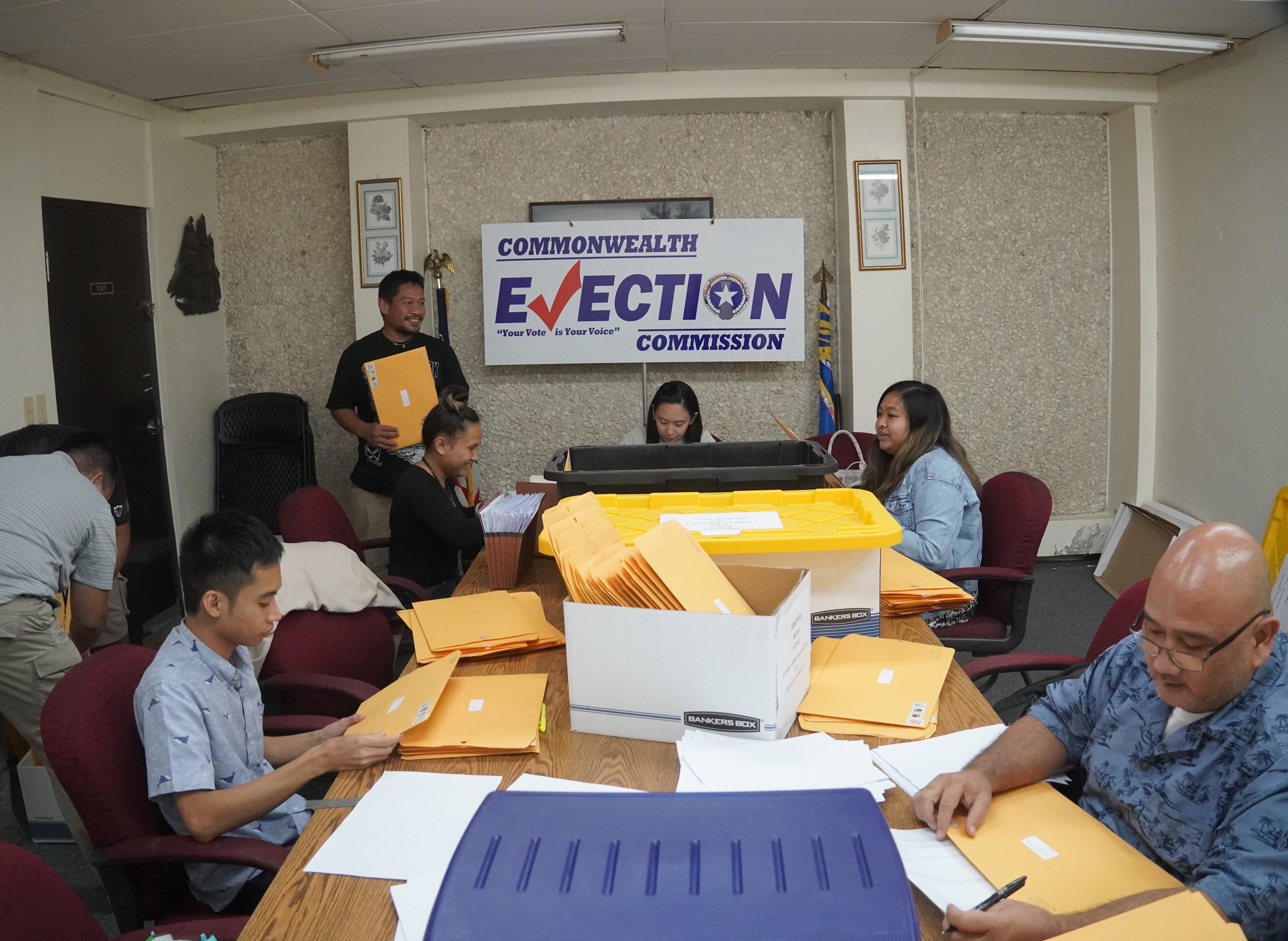 On Thursday, Office of the Public Auditor staff inspected each ballot before they are placed into envelopes sealed and packaged by Commonwealth Election Commission staff.