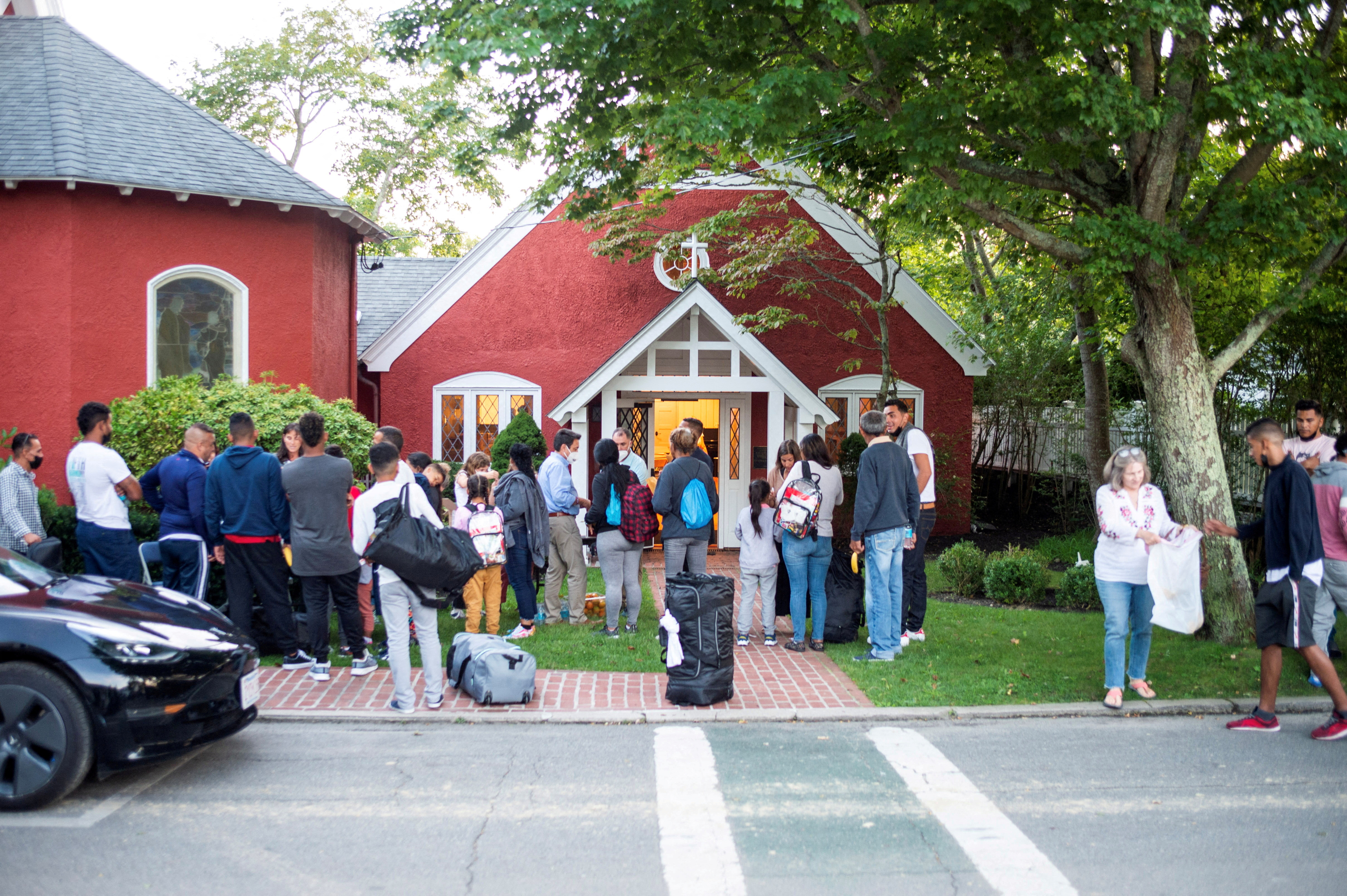 Venezuelan migrants stand outside St. Andrew's Church in Edgartown, Massachusetts on Sept. 14, 2022.