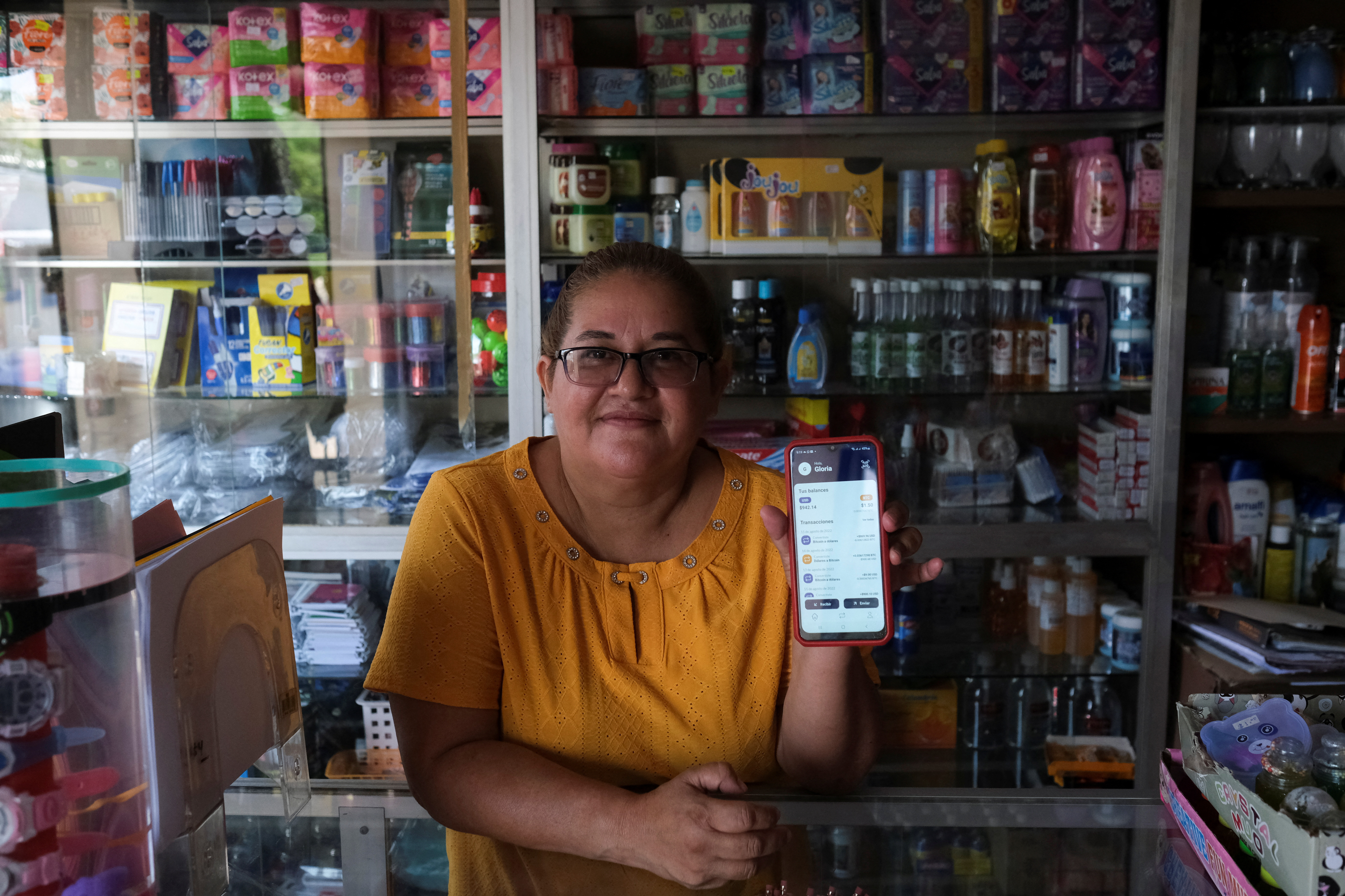 Gloria Barcia shows her Bitcoin wallet at her store in the town of Conchagua, near the projected site for the Bitcoin City in El Salvador, Aug. 19, 2022.