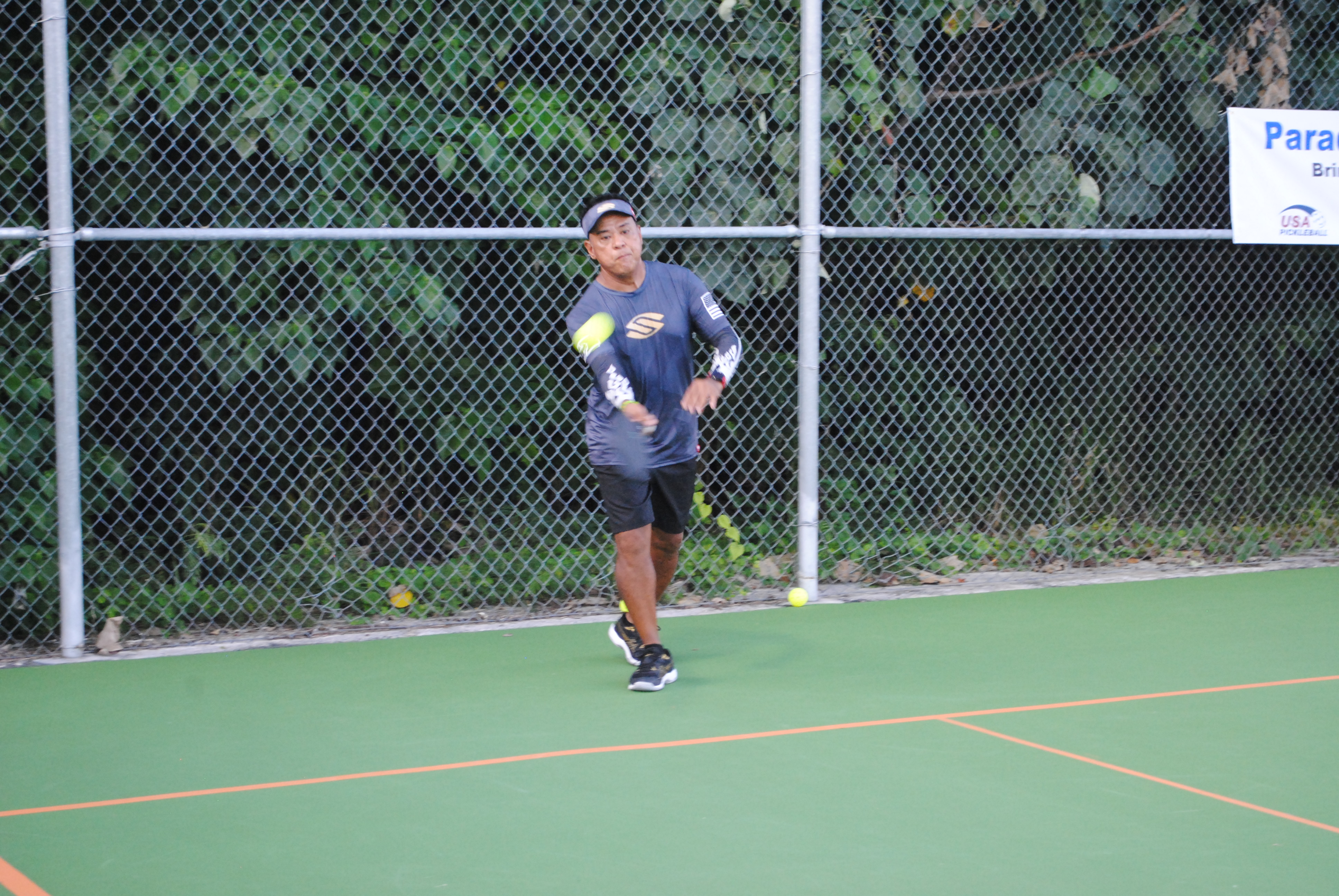 Albert Manansala, from Guam, connects the front hand return.