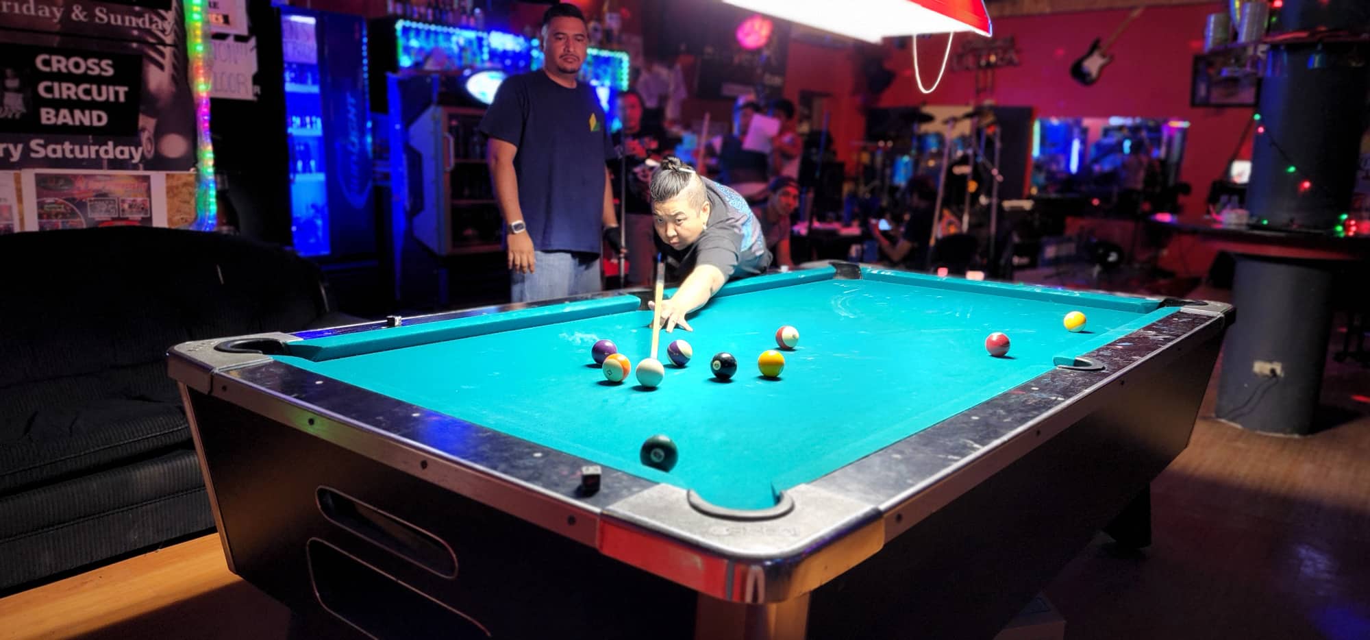 Ideal Signs JC Rustlers' Mei Rengiil lines up for a corner pocket shot during a Tuesday Division game of the SBA Budweiser Open 8-Ball League at 9 Eleven Restobar.