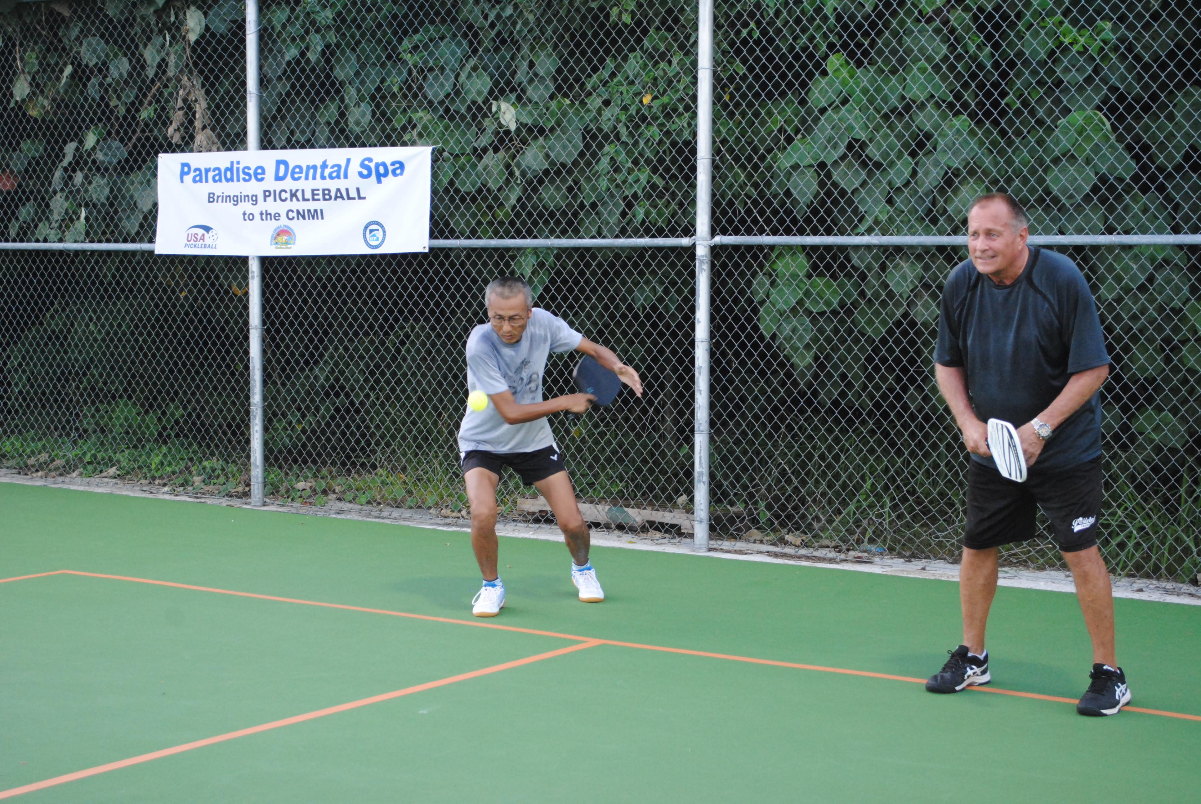 Nelson Krum, right, prepares for the play as his teammate makes the serve.