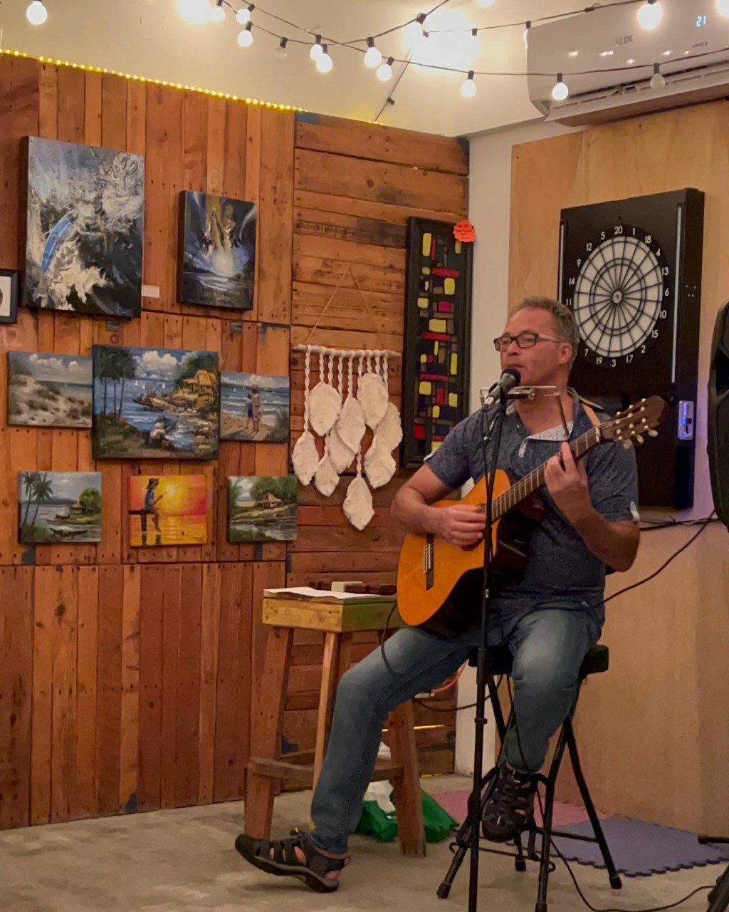 John Uhrich from Sea & Sky performs his own music with his guitar and harmonica.