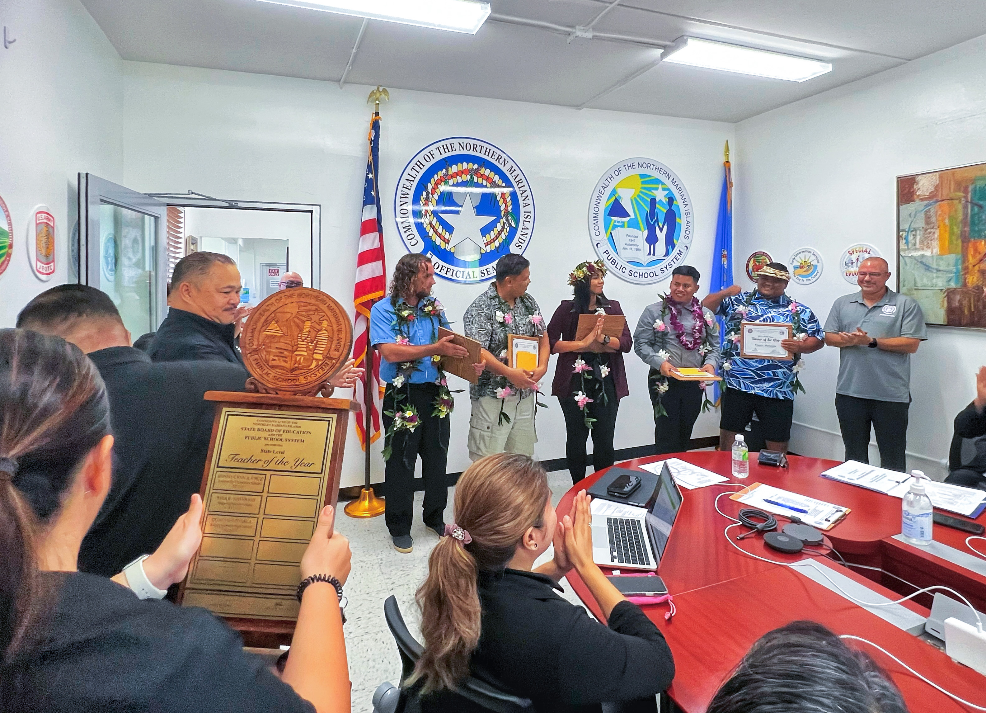 Donovan M. Tudela, 3rd right, standing, is the 2023 Teacher of the Year of the Public School System. Also in photo are the four other finalists: Daniel Wollak, Dr. Patrick Castillon, Jolene Aguon and Francis Mendiola, Board of Education Chairman Gregory Pat Borja, right, and Commissioner of Education Dr. Alfred B. Ada, left.