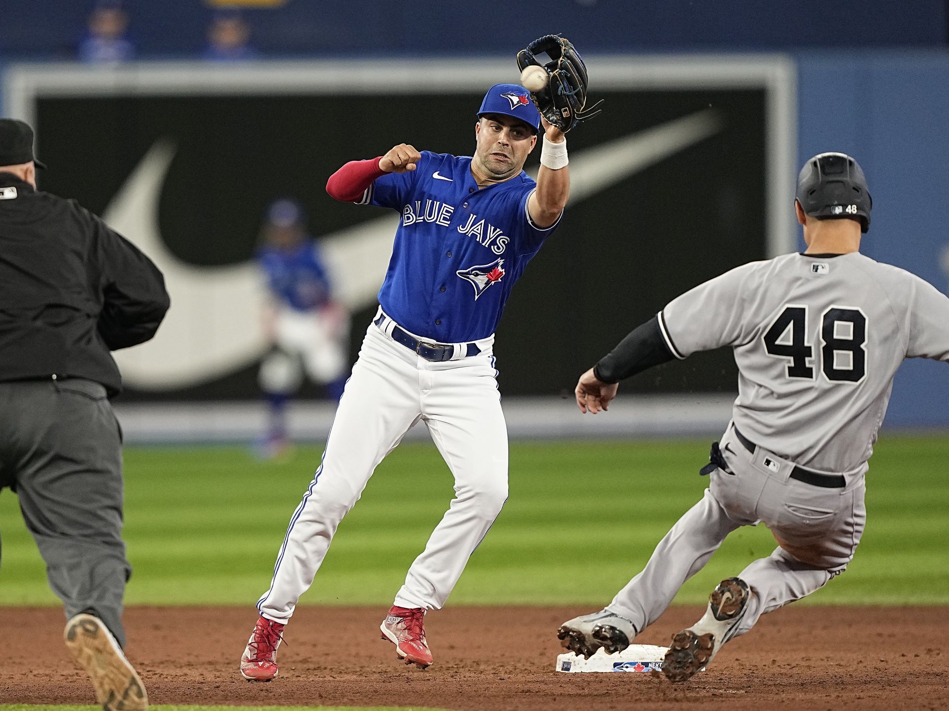 New York Yankees first baseman Anthony Rizzo (48) gets caught stealing by Toronto Blue Jays second baseman Whit Merrifield (1) during the eighth inning at Rogers Centre in Toronto, Ontario, Canada on Sept. 26, 2022.