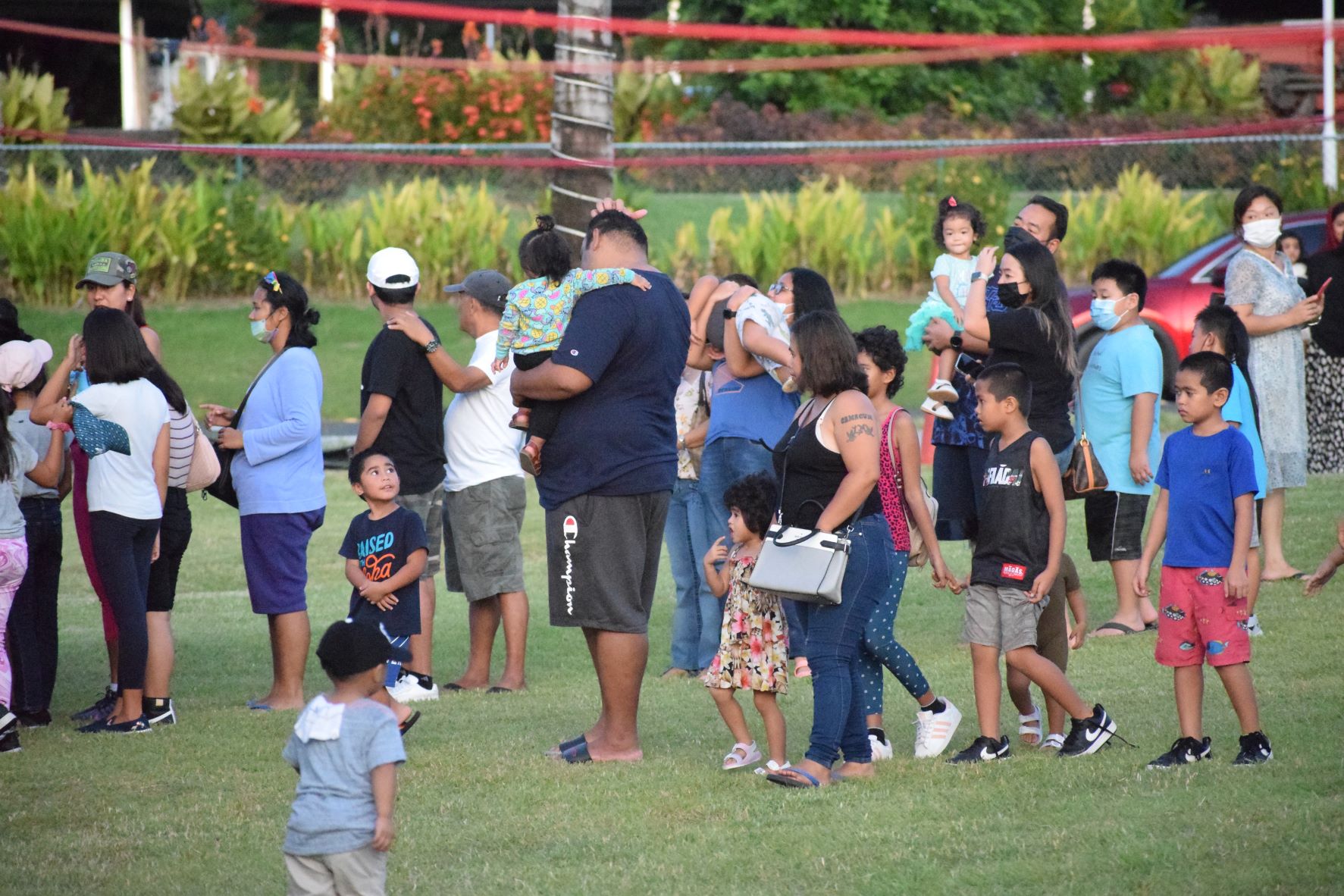 Children and their parents line up for Island Shave Ice during the opening of Fiesta Friday at the NMI Museum grounds on Friday.