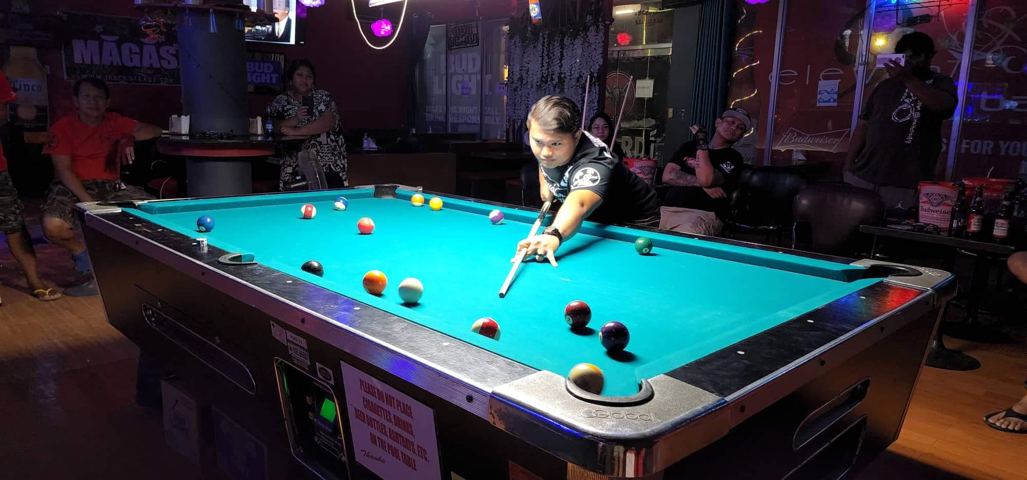 Bamboo Soudelor Construction's Frankie Blas lines up for the shot during a Thursday Division game of the SBA Budweiser Open 8-Ball League at 9 Eleven Restobar.
