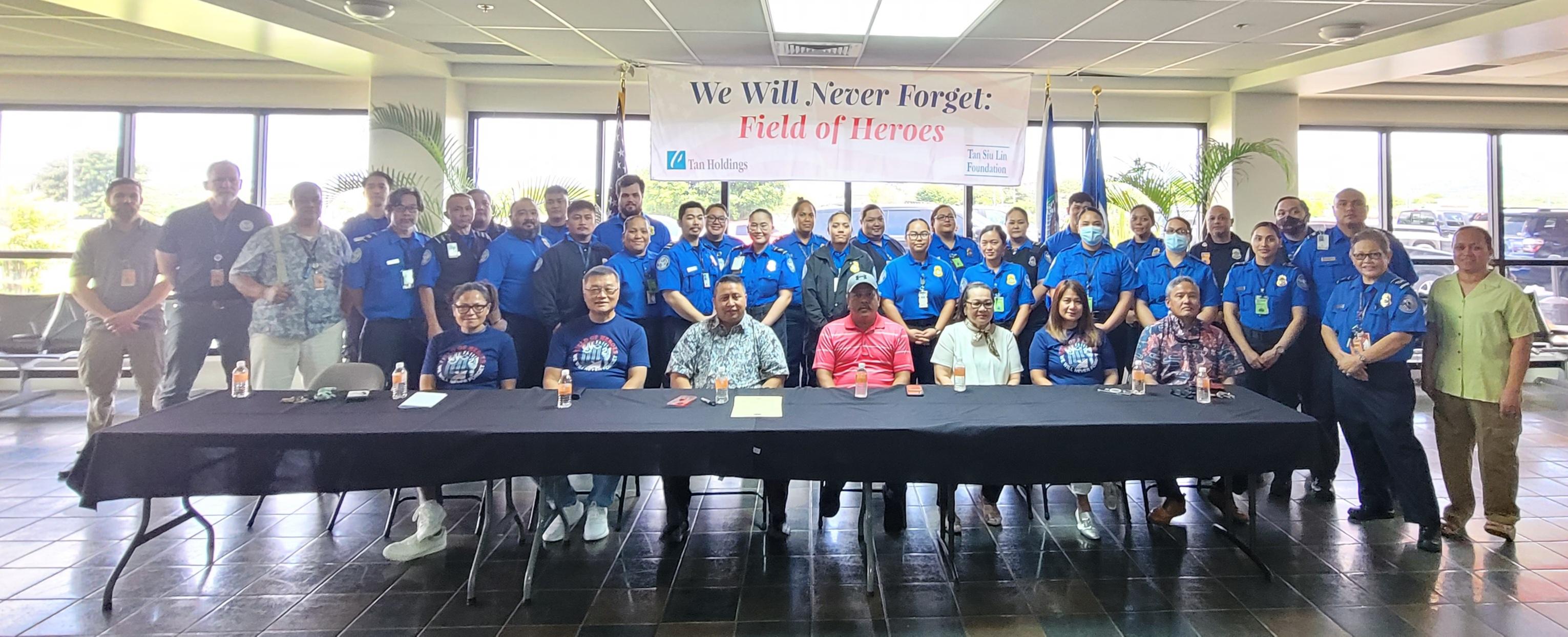 Transportation Security Administration agents pose for a photo with officials.