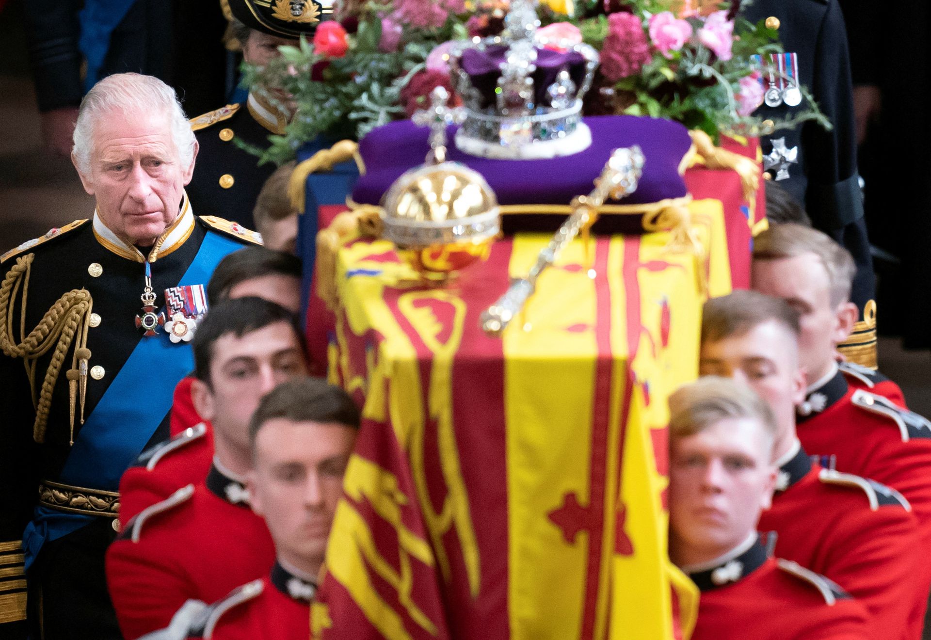 King Charles III and members of the royal family follow behind the coffin of Queen Elizabeth II, draped in the Royal Standard with the Imperial State Crown and the Sovereign's orb and scepter, as it is carried out of Westminster Abbey after her state funeral, Monday Sept. 19, 2022.