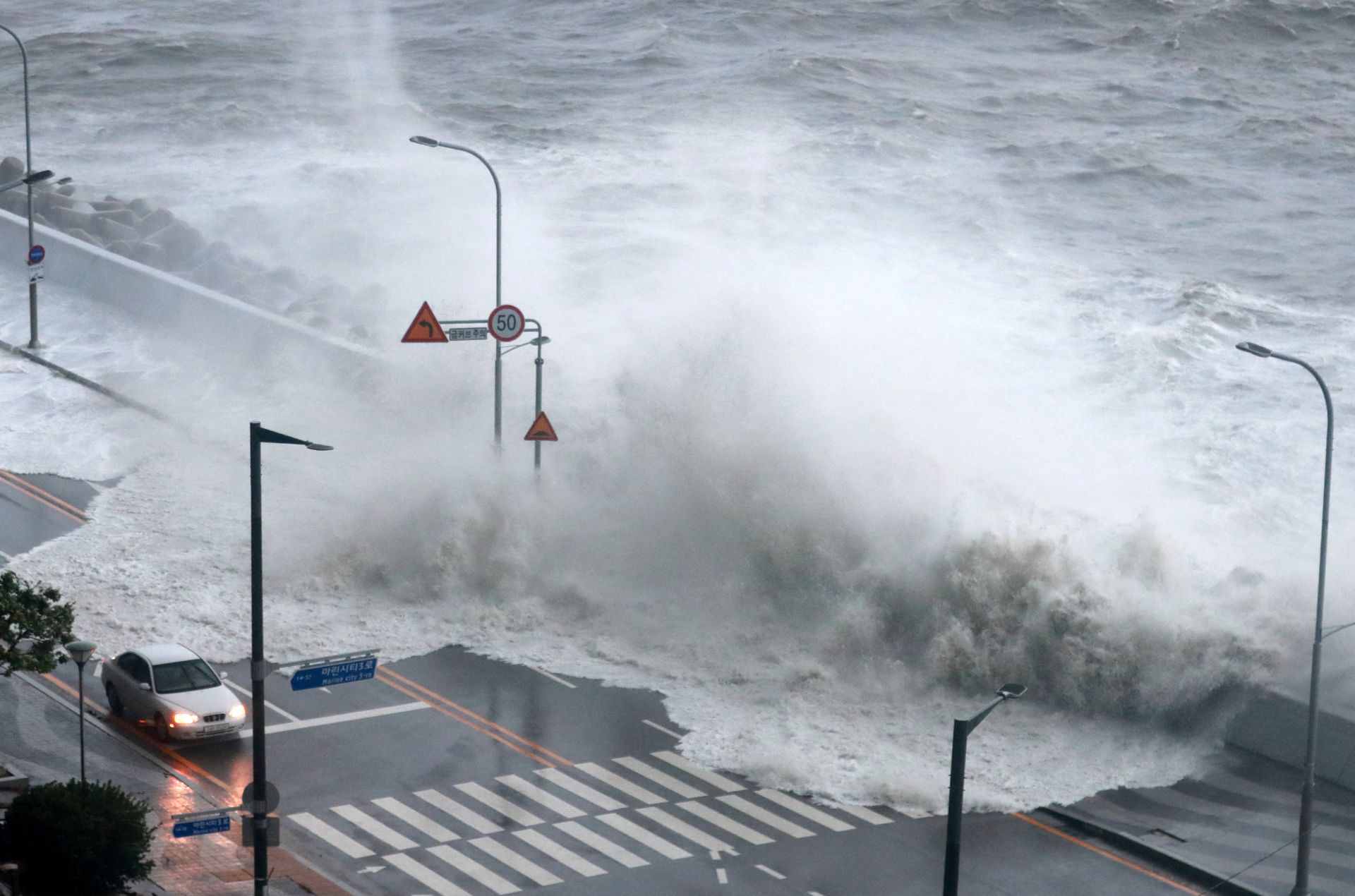 A wave caused by Typhoon Hinnamnor hits the waterfront in Busan, South Korea, Sept. 6, 2022.