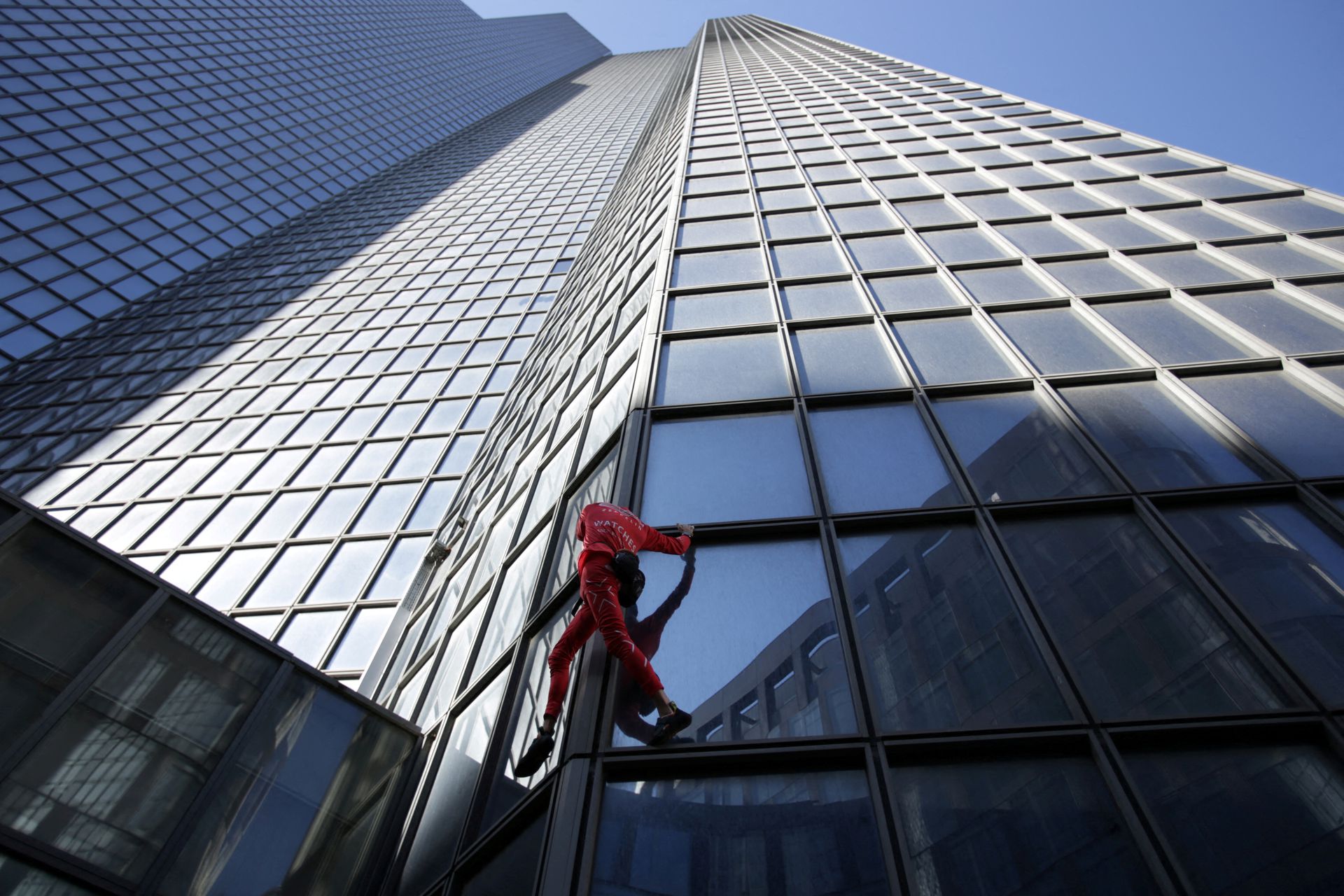 French "Spiderman," Alain Robert, climbs the TotalEnergies skyscraper in La Defense near Paris, France Sept. 17, 2022.