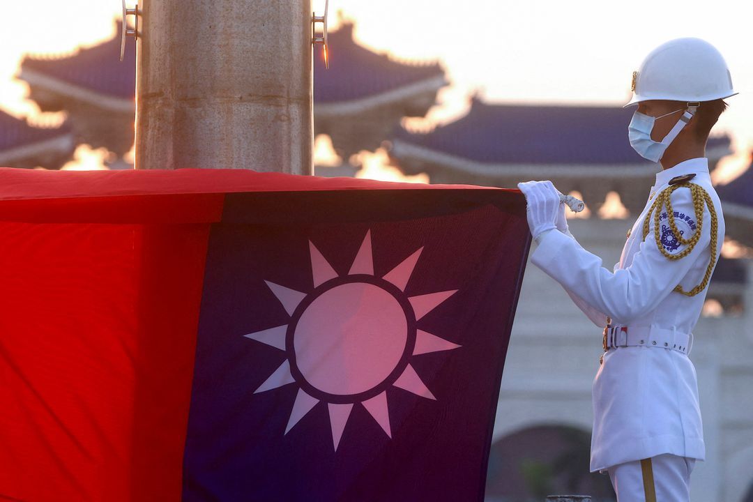 Honor guards lower the Taiwan flag during sunset hours at Liberty Square in Taipei, Taiwan, July 28, 2022.