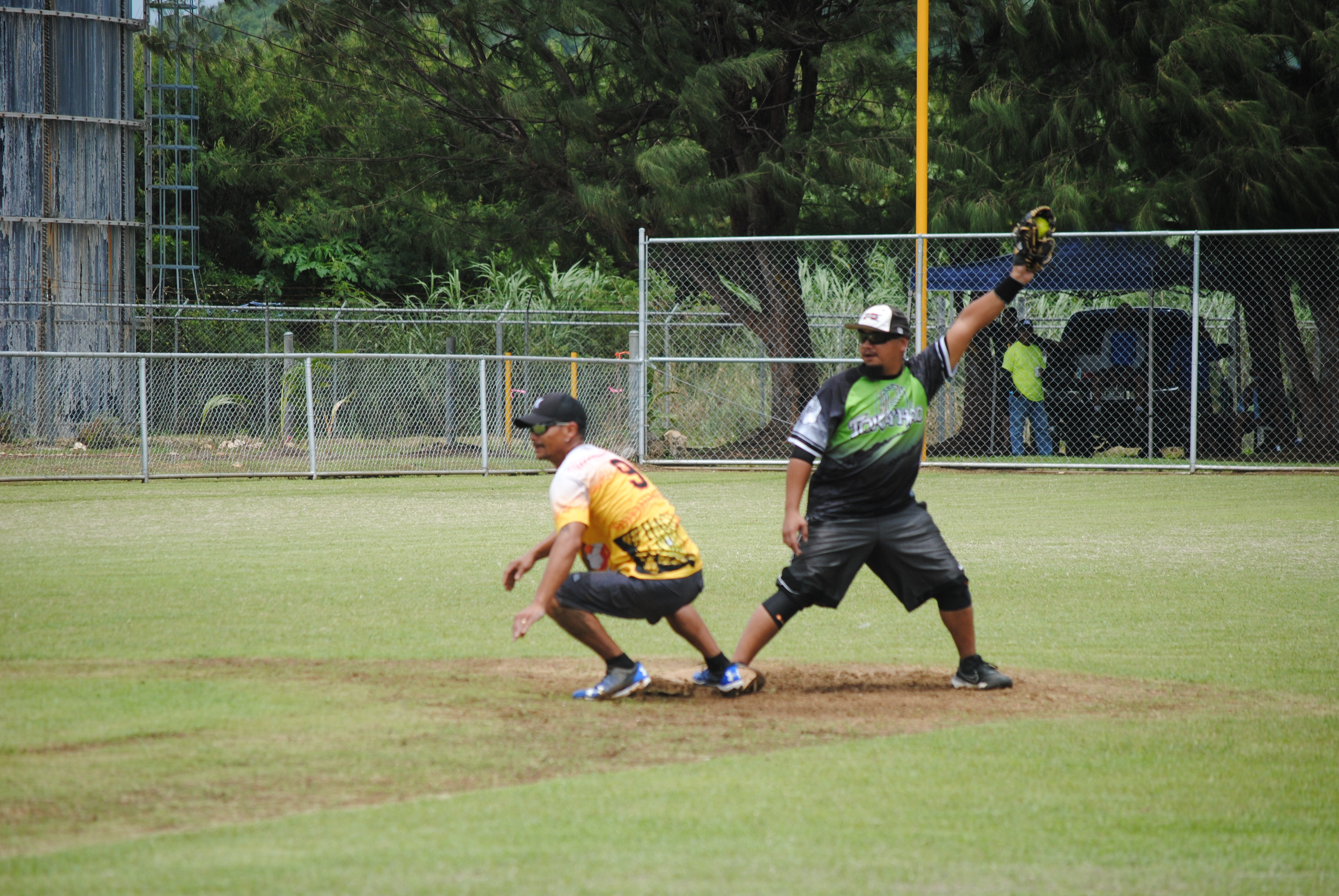 Tokahao second baseman Mark Villagomez catches the ball for the out during a 2022 Budweiser Belau Amateur Softball League game Sunday at the Dandan baseball field.