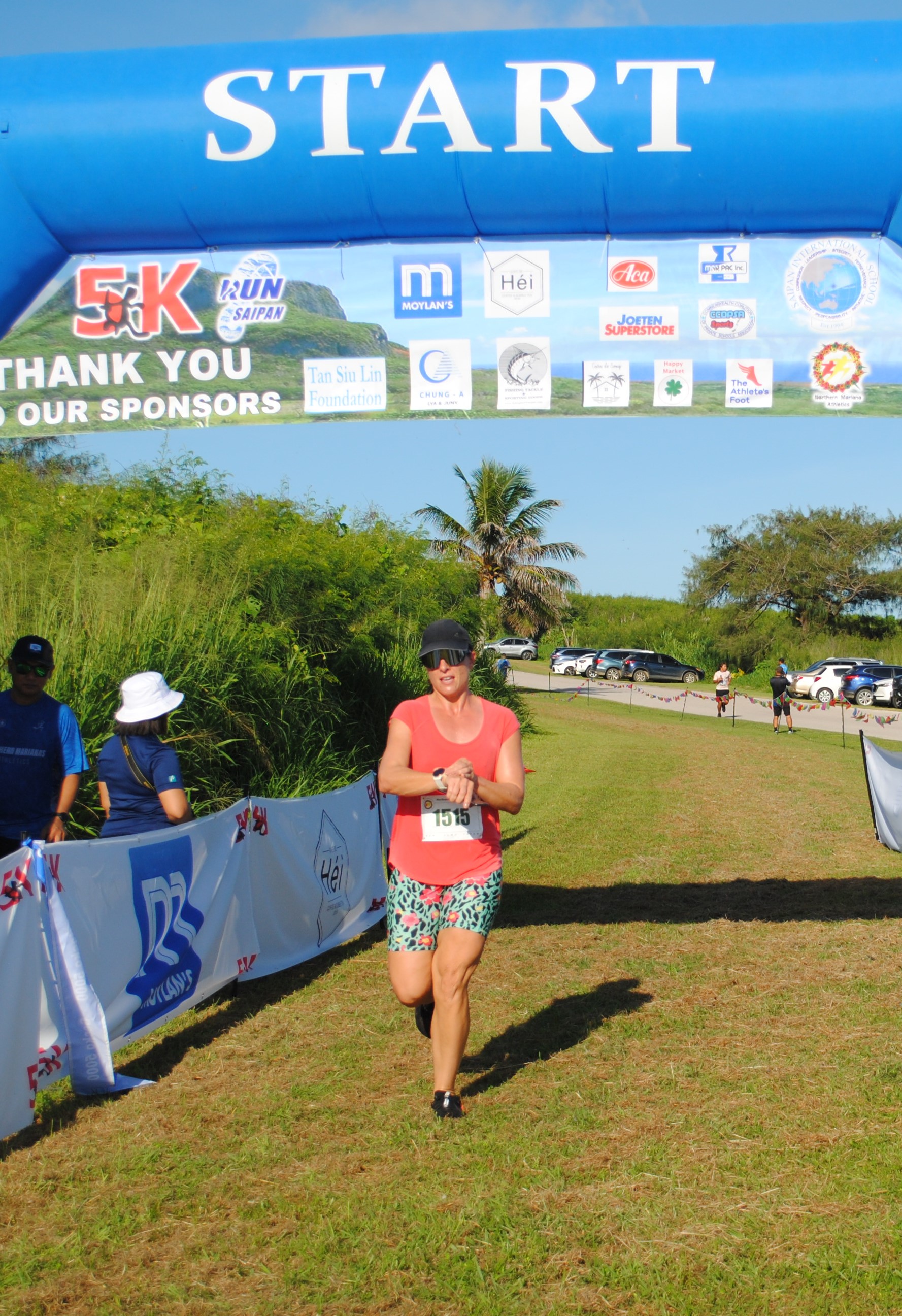 Robyn Spaeth crosses the finish line of the Gecko 5000 Open Women's 6K Division Saturday at  Banzai Cliff.