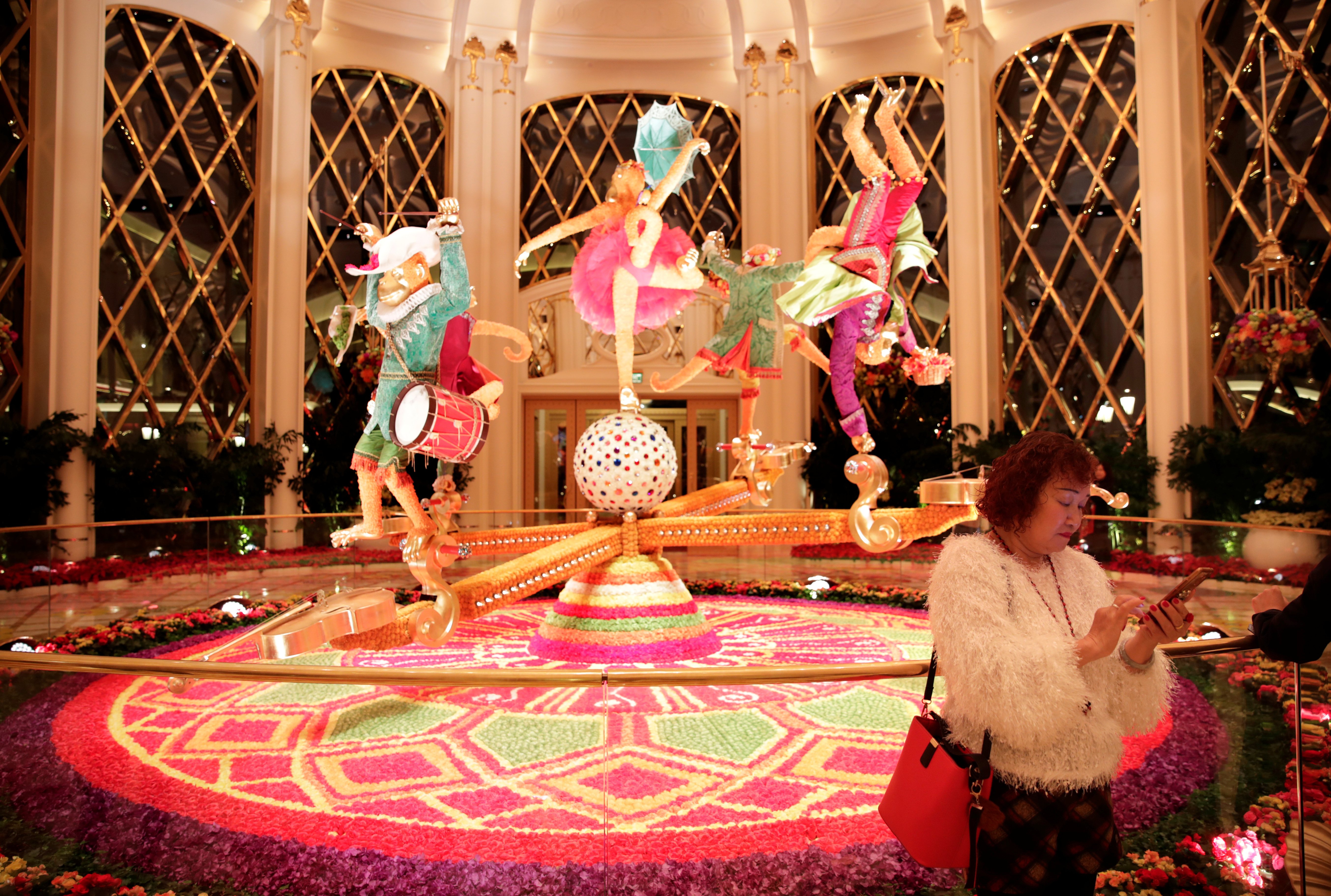 A woman is seen next to the decoration inside the Wynn Palace casino resort in Macau, Dec. 20, 2019, on the 20th anniversary of the former Portuguese colony's return to China.