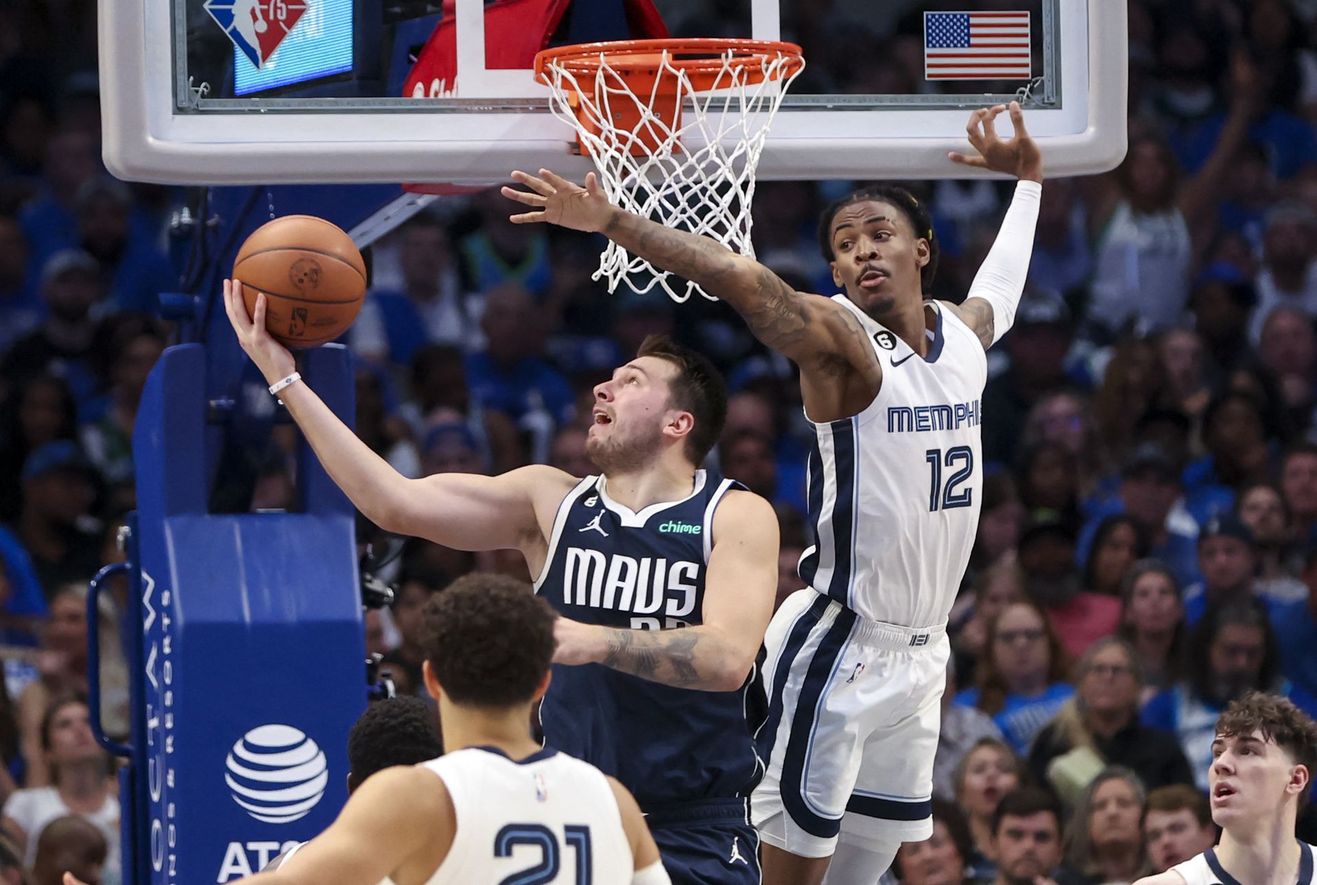 Dallas Mavericks guard Luka Doncic (77) shoots as Memphis Grizzlies guard Ja Morant (12) defends during the second half at American Airlines Center in Dallas, Texas, Oct. 22, 2022.
