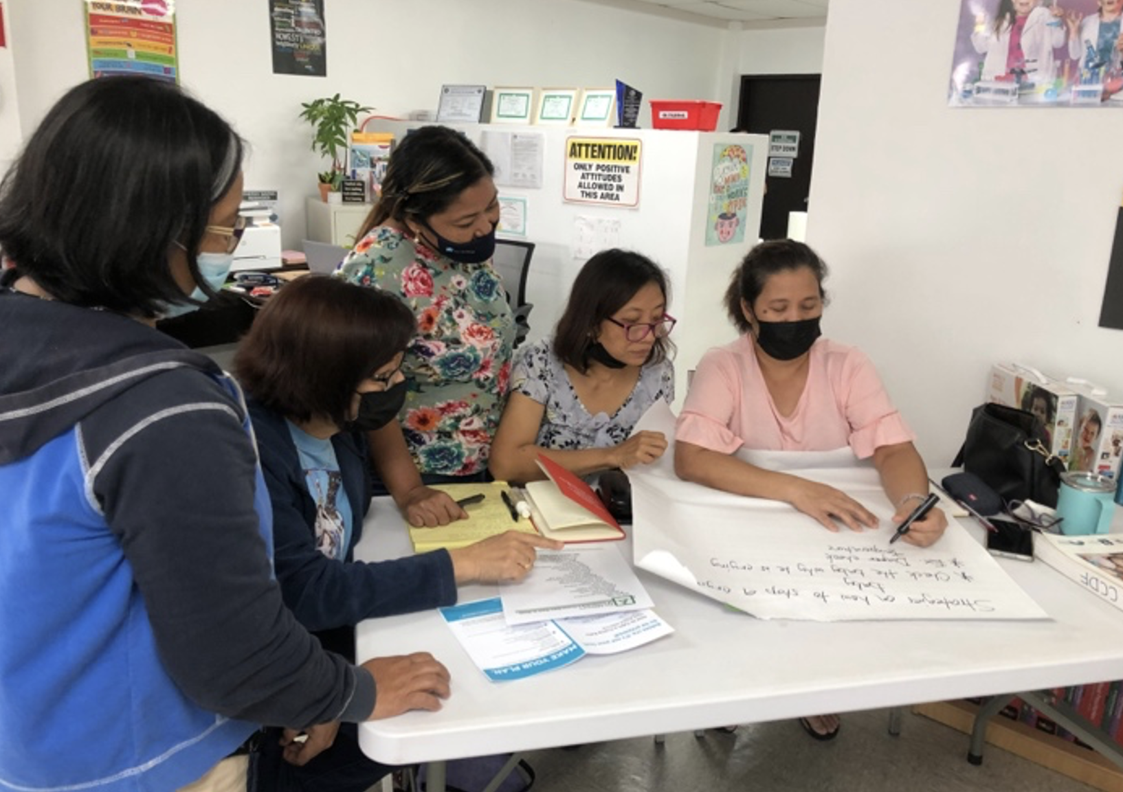 Child care providers attend a health and safety training session.