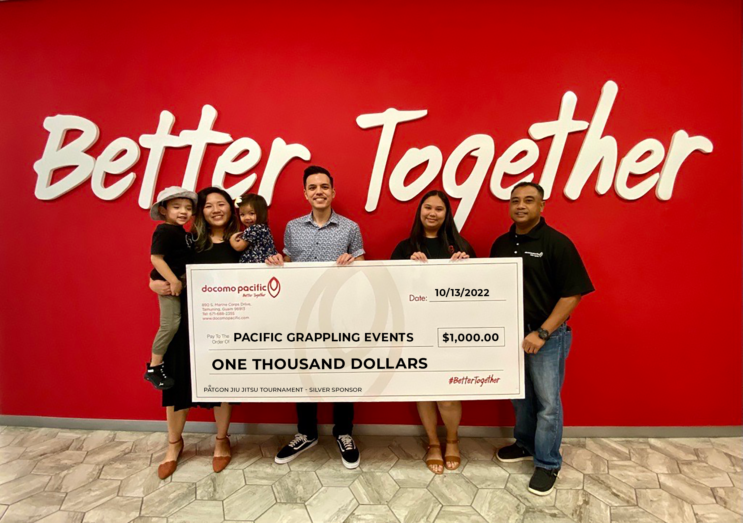 Påtgon Jiu-Jitsu Tournament check presentation. From left, Jayronne Gandaoli, founder and event coordinator, Pacific Grappling Events; Jared Roberto, public relations manager, Docomo Pacific; Victoria Quichocho, prepaid sales lead, Docomo Pacific; and Benjamin Estampador, Reseller sales lead, Docomo Pacific. 