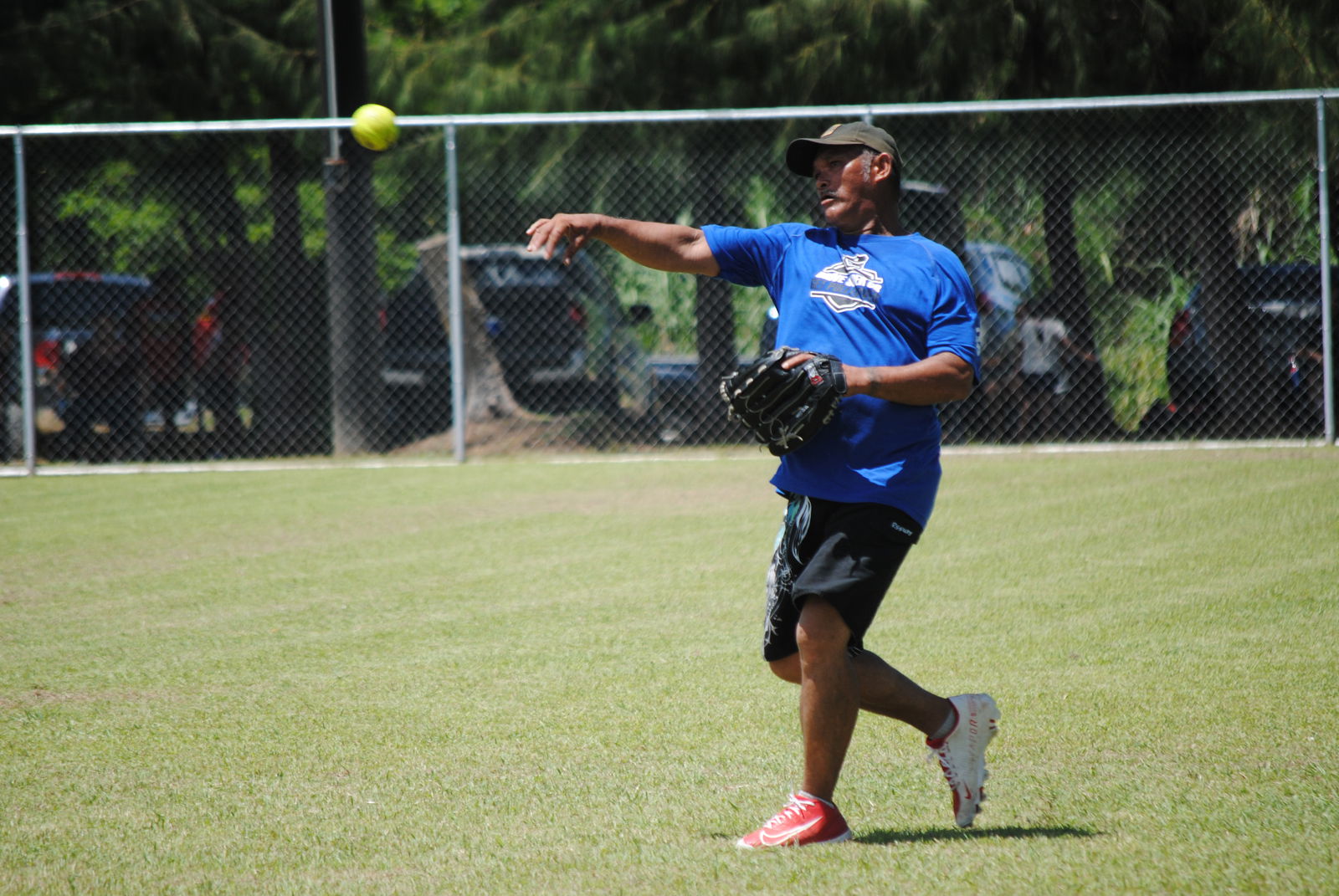 SUFA first baseman Mel Tenorio throws the ball infield after catching a flyball for an out during a 2022 Budweiser Belau Amateur Softball League game at the Dandan baseball field.