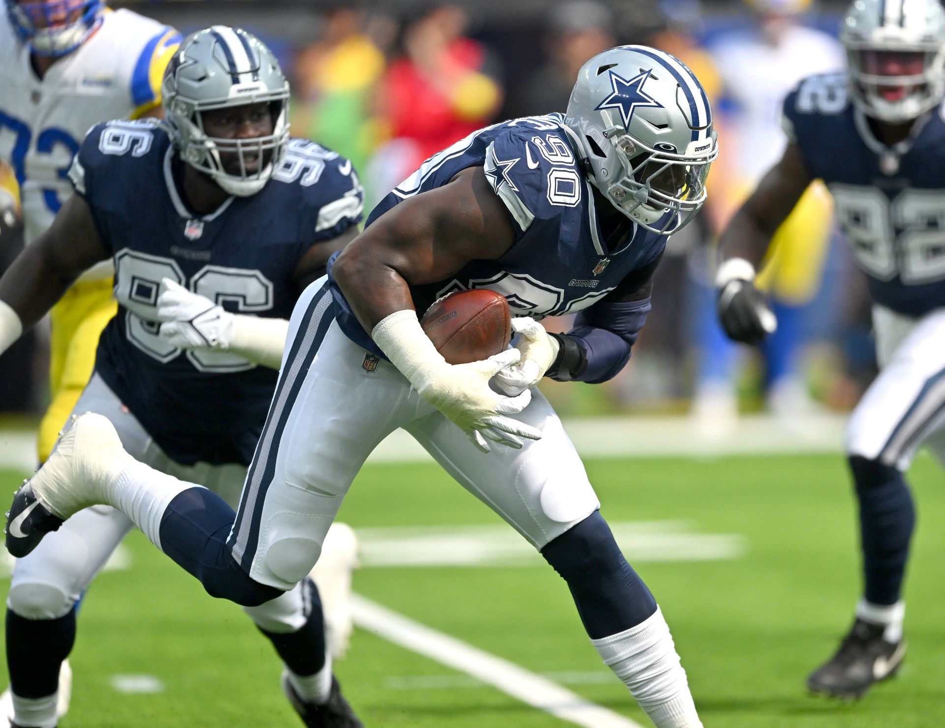 Dallas Cowboys defensive end DeMarcus Lawrence (90) recovers a fumble by Los Angeles Rams quarterback Matthew Stafford — not pictured — for a touchdown in the first quarter the game at SoFi Stadium in Inglewood, California, Oct. 9, 2022.